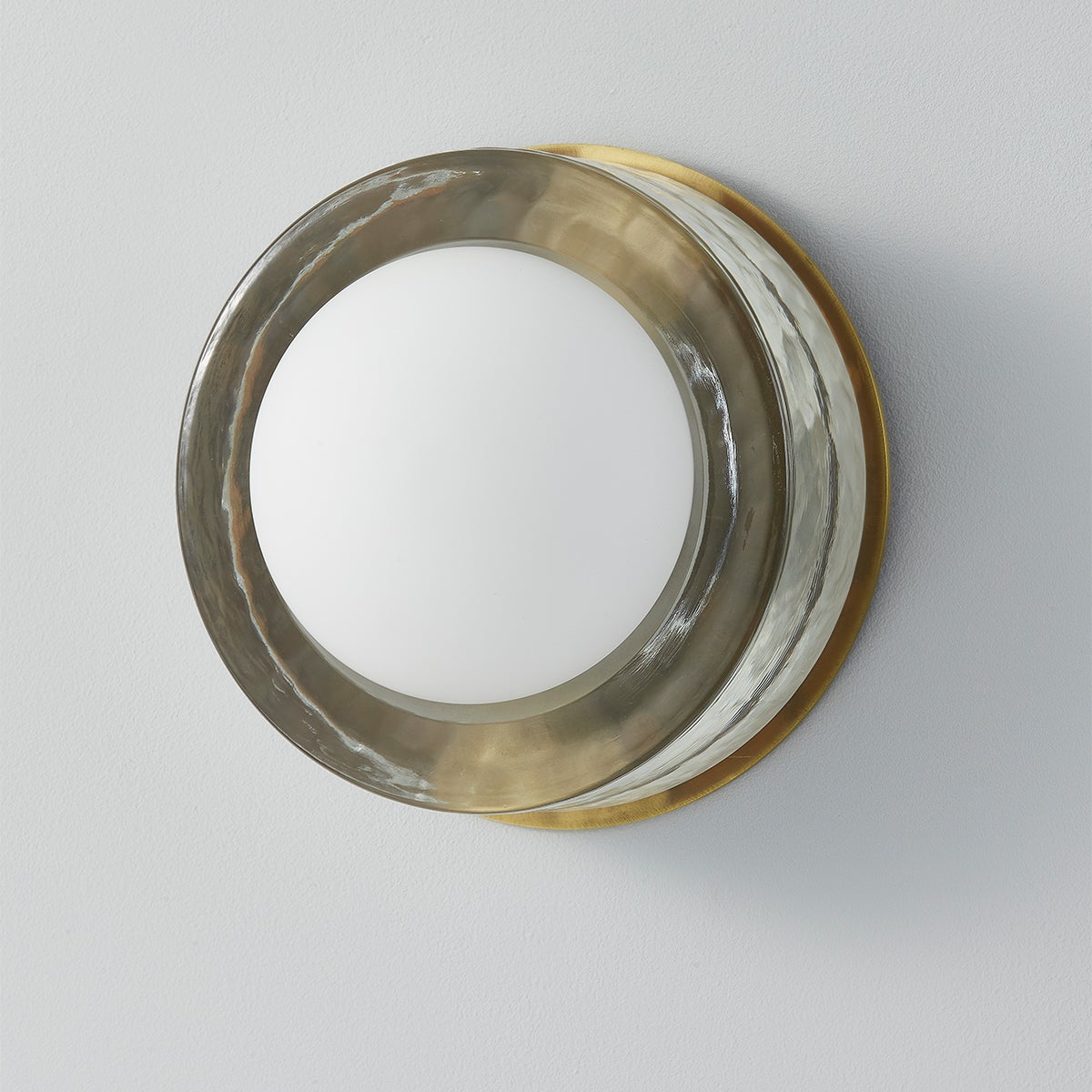 Mackay Wall Sconce 7.75" x 0" in aged brass shown from the front to reveal the arm curve and shade silhouette.