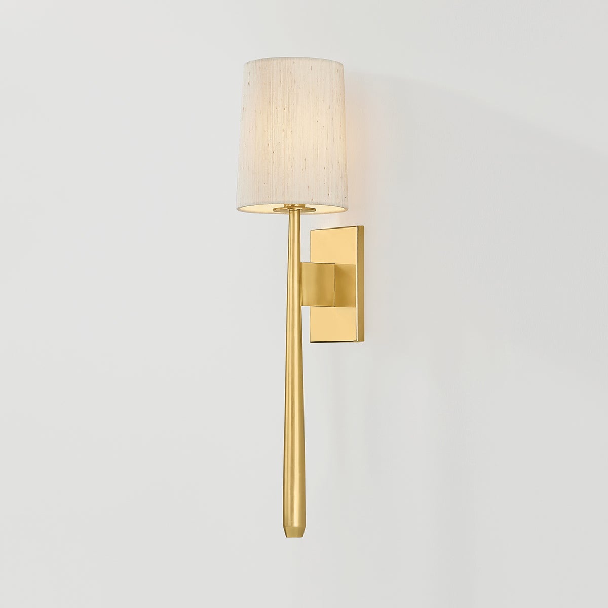 Close-up of the Bridgeton Wall Sconce in aged brass showing the arm curve and shade silhouette.