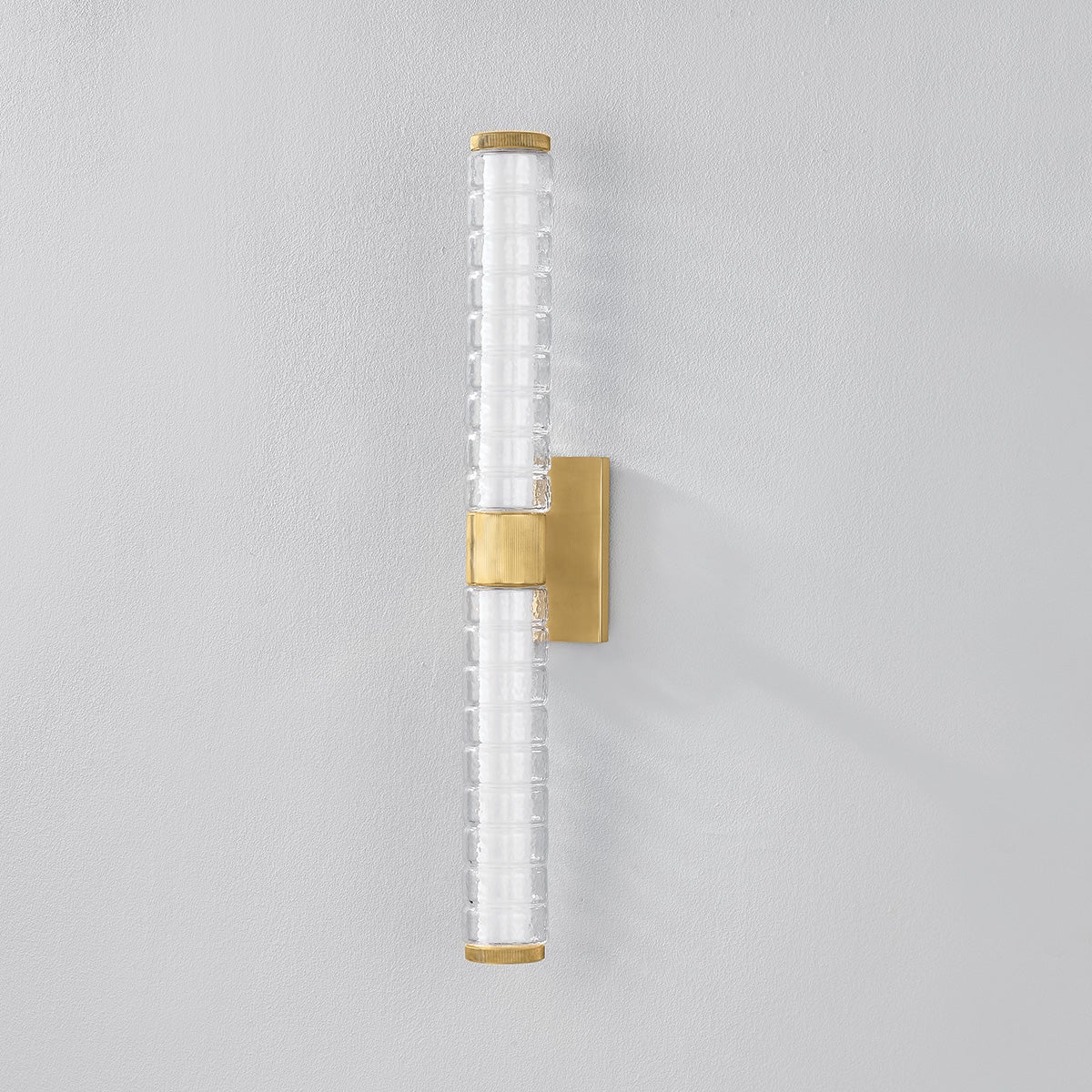 Castor Bath Sconce 4.25" x 24.25" in aged brass shown from a second angle to highlight the arm spread and shade silhouette.