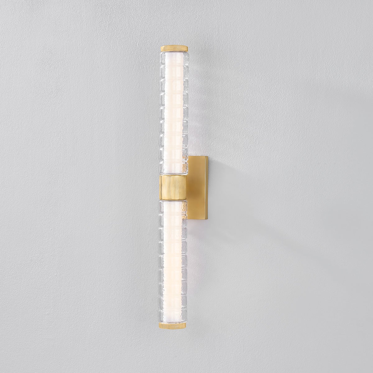 Castor Bath Sconce 4.25" x 24.25" in aged brass shown from the front to reveal the arm spread and shade silhouette.