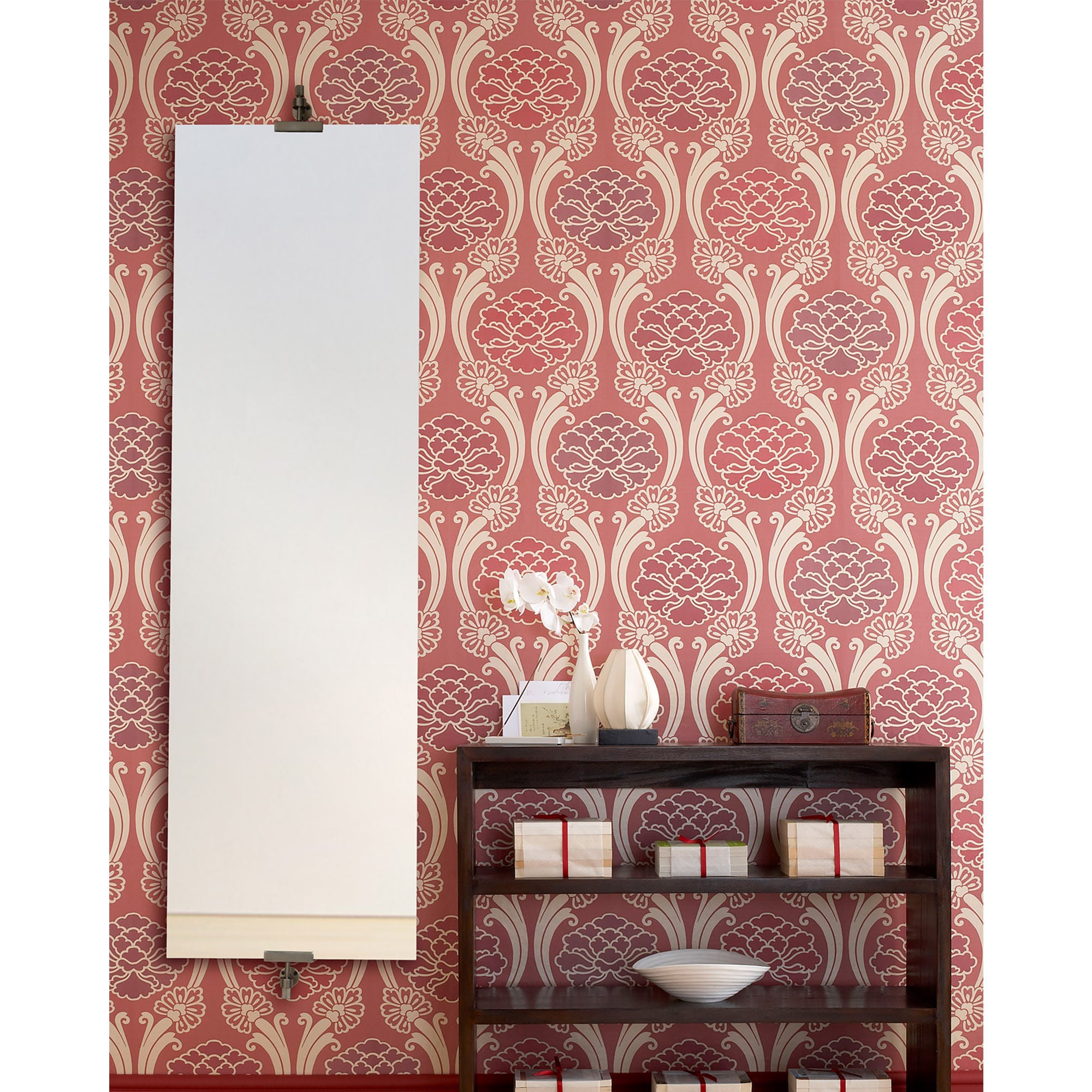 Ashlar mirror mounted on a patterned red wallpaper, complementing a stylish interior setting.