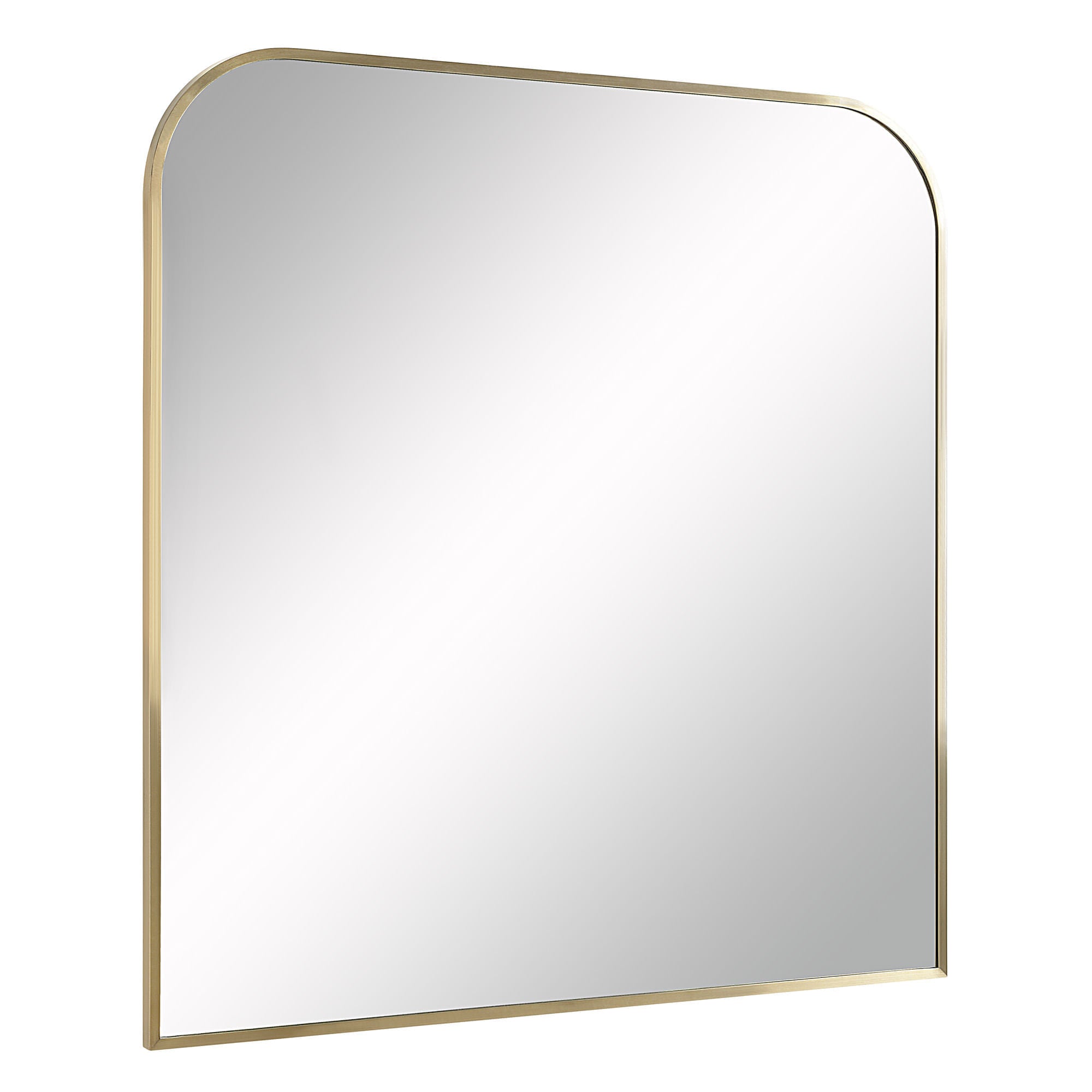 Joan mirror with a rounded top and antique brushed brass frame, reflecting light.