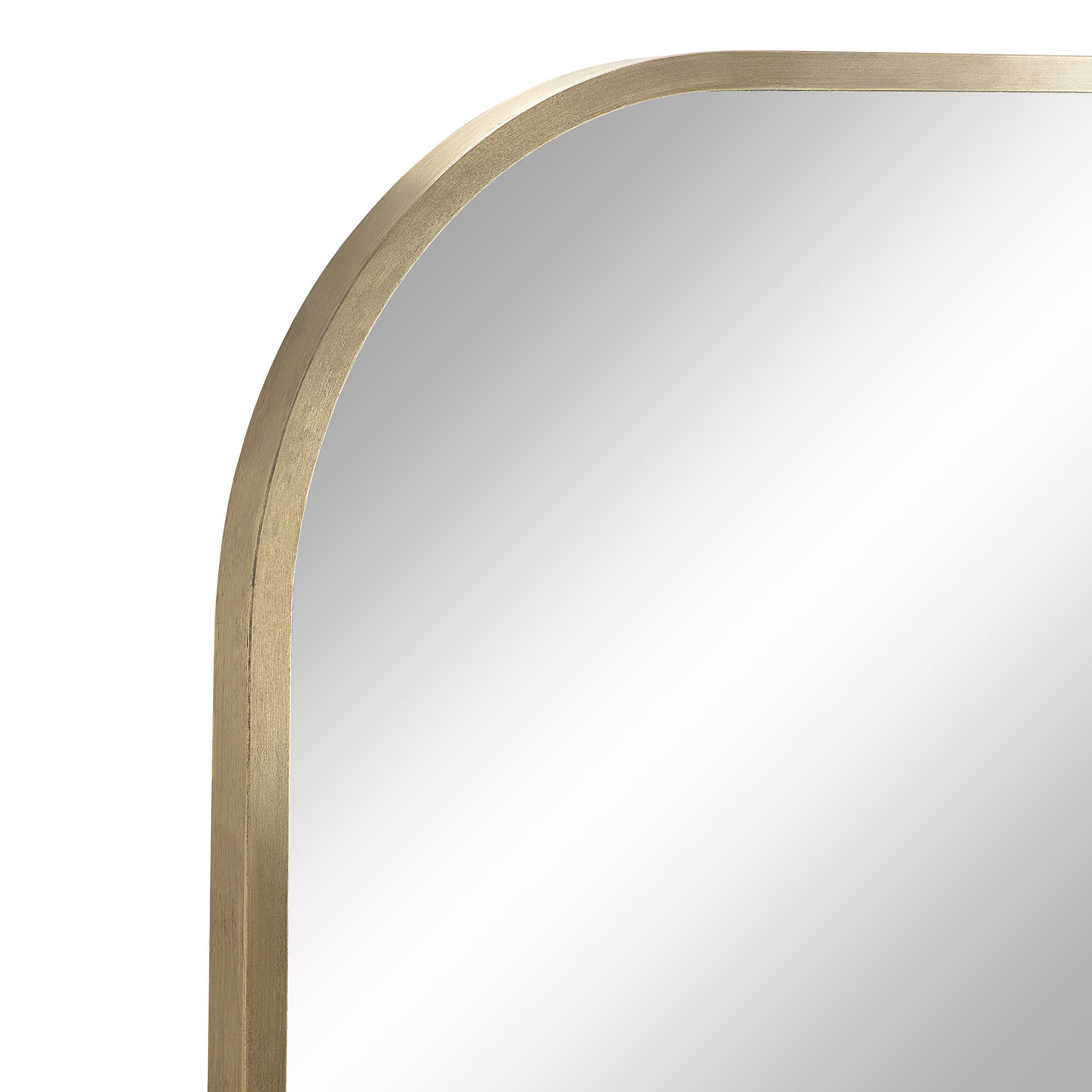 Close-up of Joan mirror's rounded edge with antique brushed brass finish.