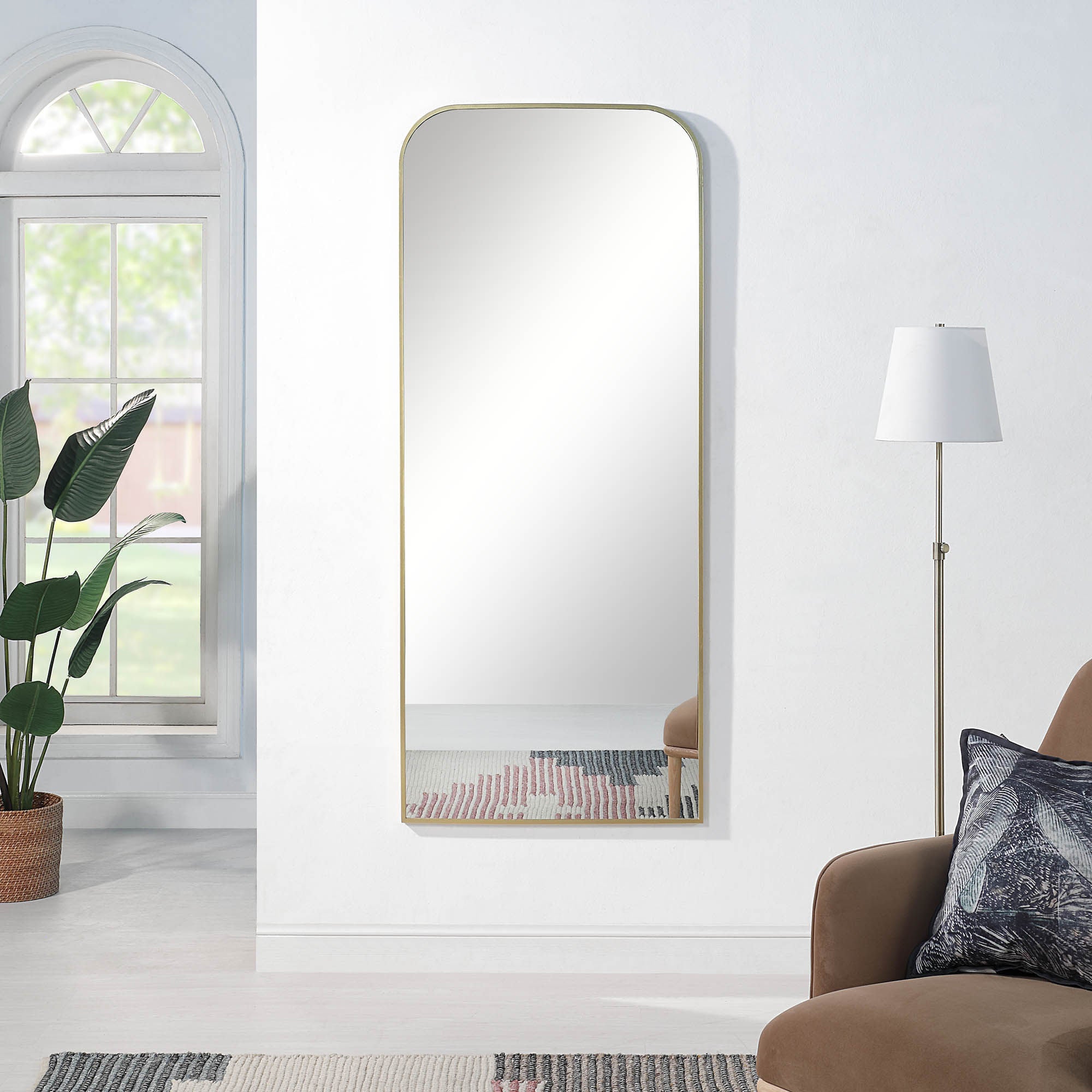 Meryem mirror by Renwil, styled in a room with plants and a lamp, gold frame