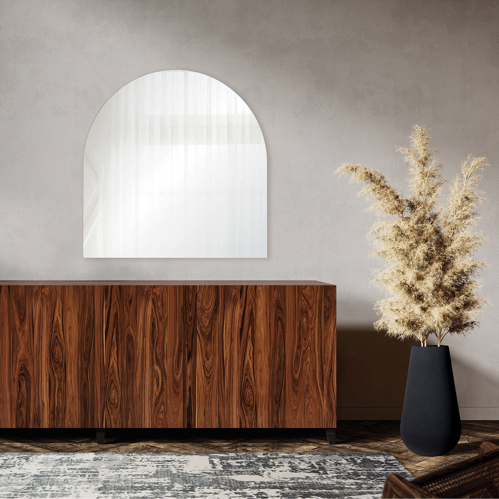 Beasley mirror displayed above a wooden cabinet in a modern interior setting with a decorative plant.