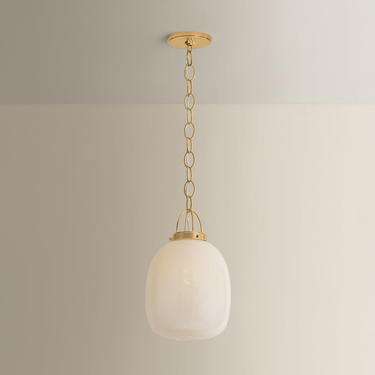 Close-up of the Enosburg Pendant 11" in aged brass showing the shade shape and metal detail.