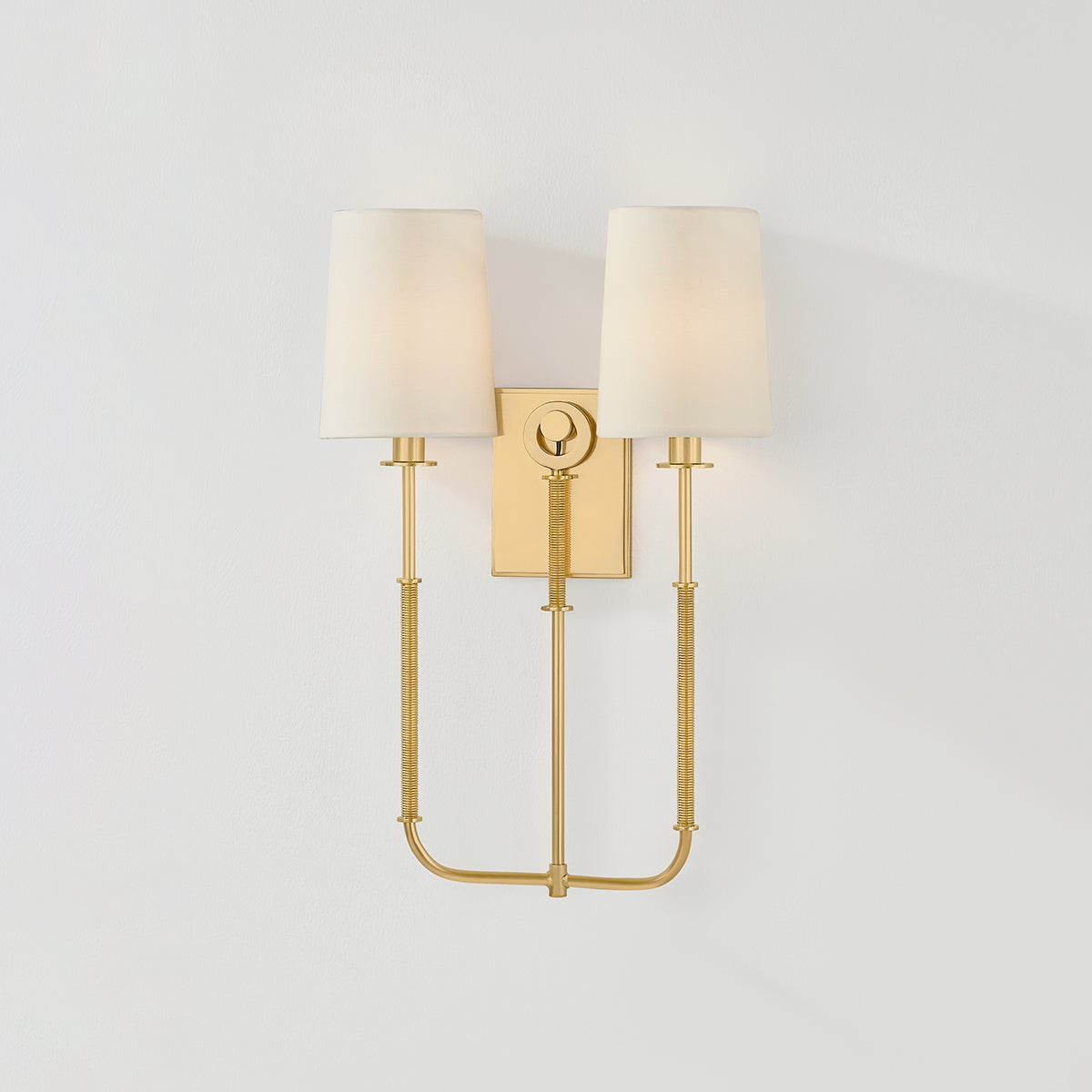 Close-up of the Glenmont Wall Sconce 14" in aged brass showing the arm curve and shade silhouette.