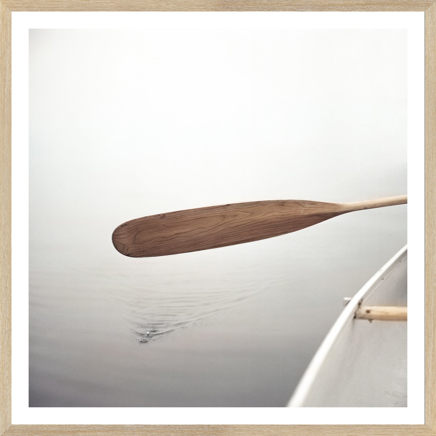 The Paddle wall art depicting a wooden paddle above serene water
