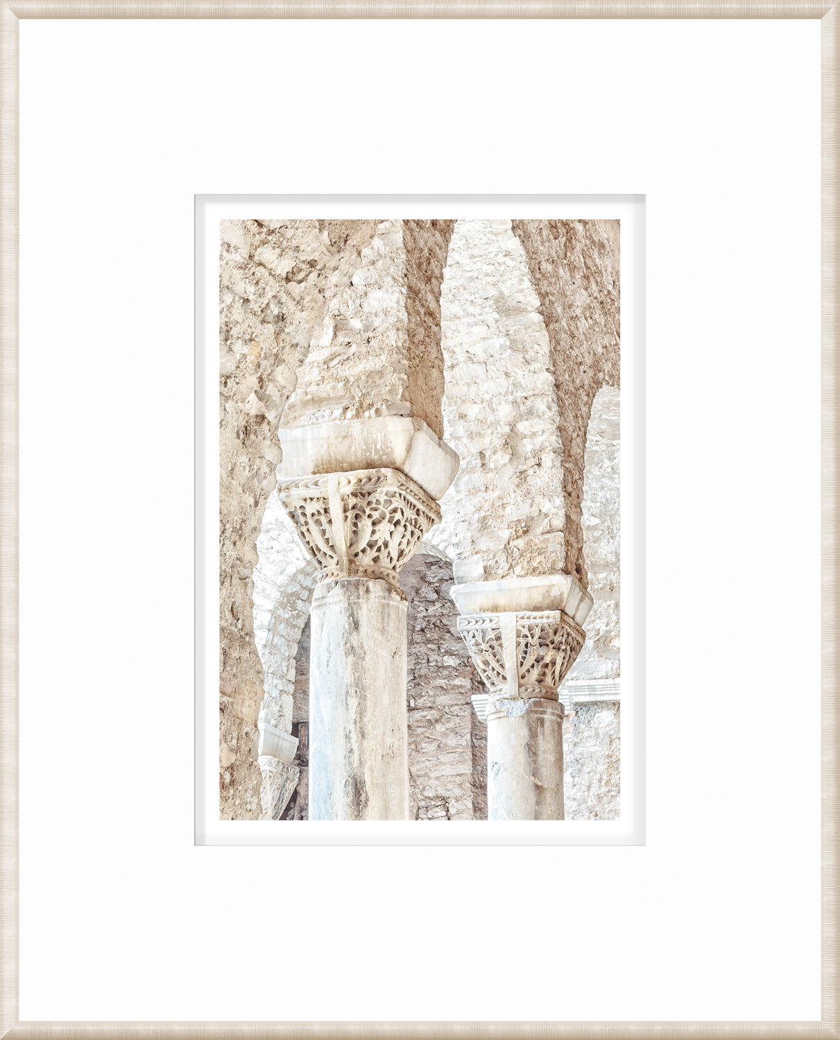 Framed masonry wall art showcasing detailed stone columns in Porec, Croatia.