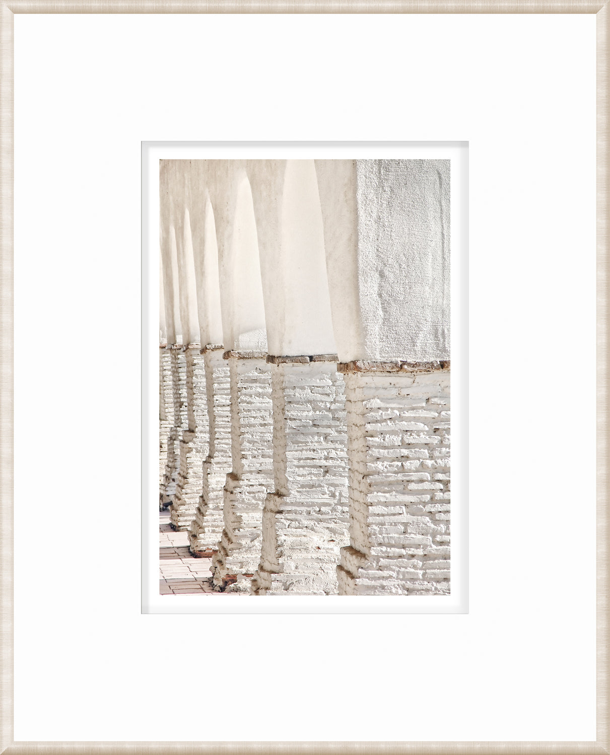 Masonry – Colonnade wall art showcasing white arches and textured columns in a bright view.