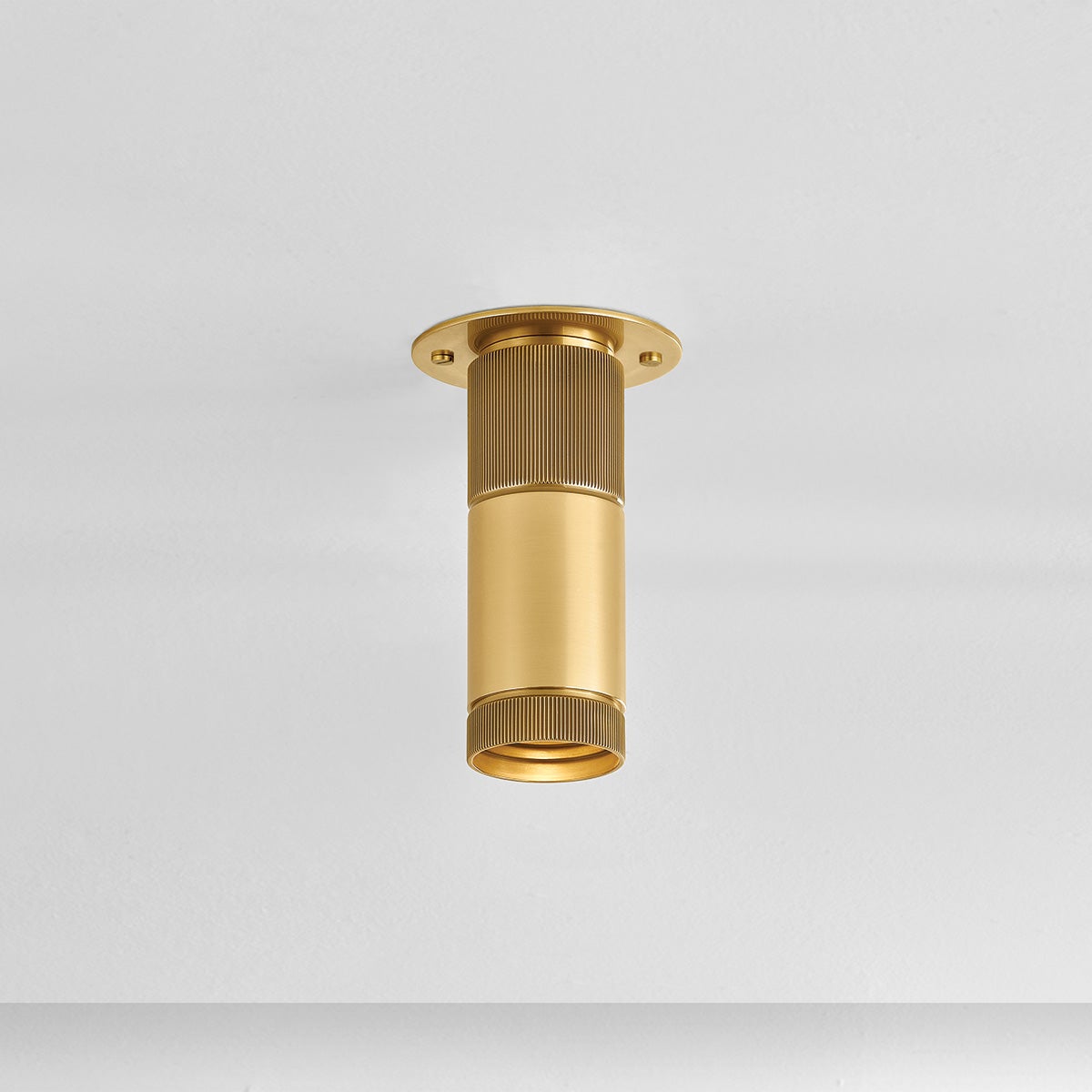 Dighton Flush Mount in aged brass shown from the front to reveal the shade profile and mounting canopy.