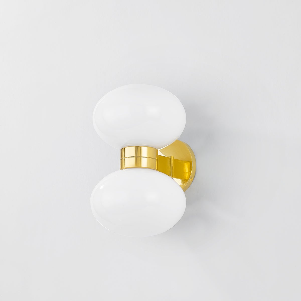 Close-up of the Otsego Wall Sconce in aged brass showing the arm curve and shade silhouette.
