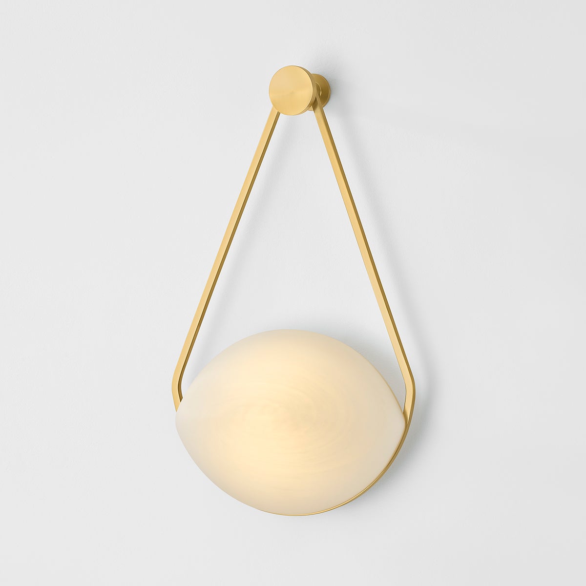 Blaina Wall Sconce in aged brass shown from the front to reveal the arm curve and shade silhouette.