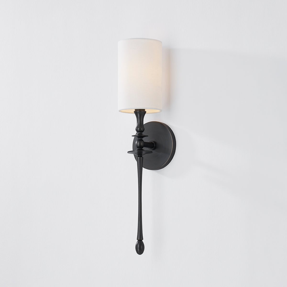 Close-up of the Guilford Wall Sconce in dark bronze showing the arm curve and shade silhouette.