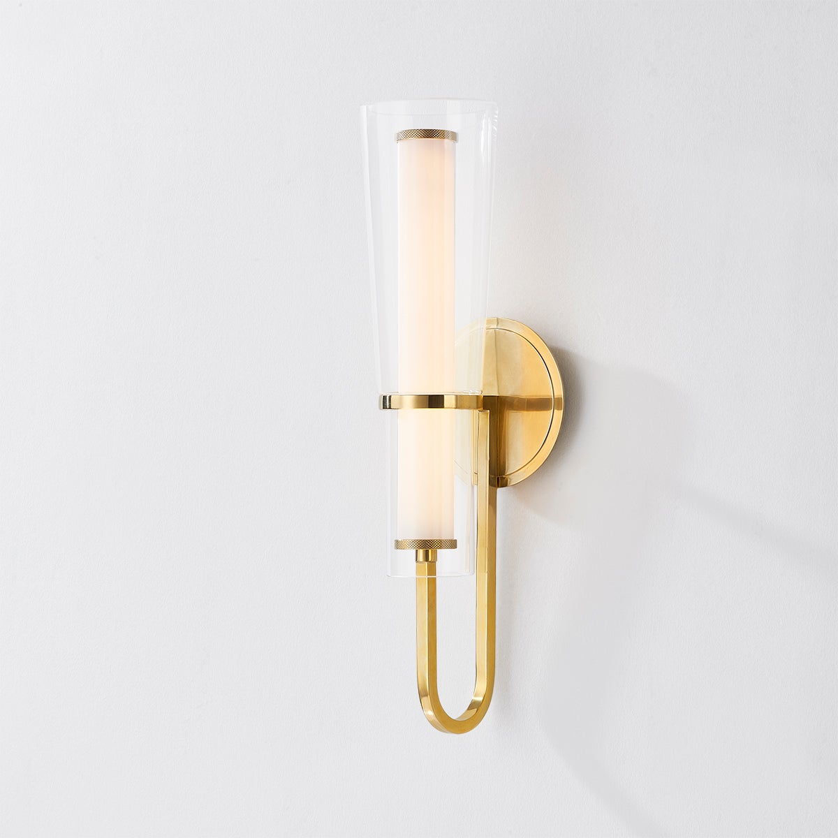 Close-up of the Vancouver Wall Sconce in aged brass showing the arm curve and shade silhouette.