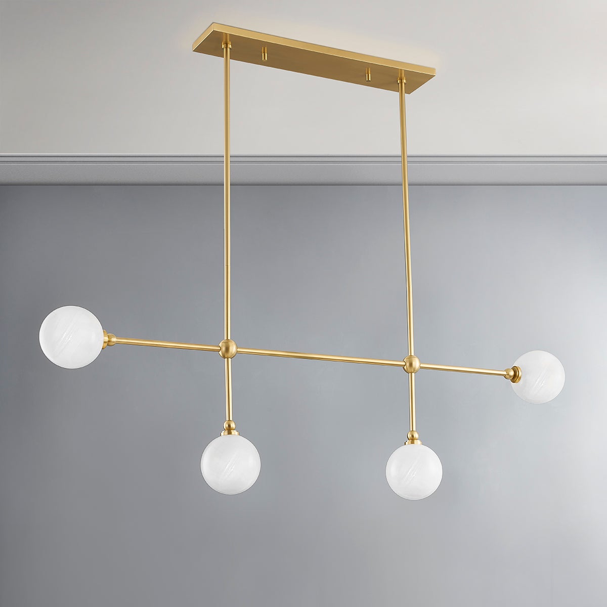 Andrews Linear in aged brass shown from a second angle to highlight the extended frame and shade array.