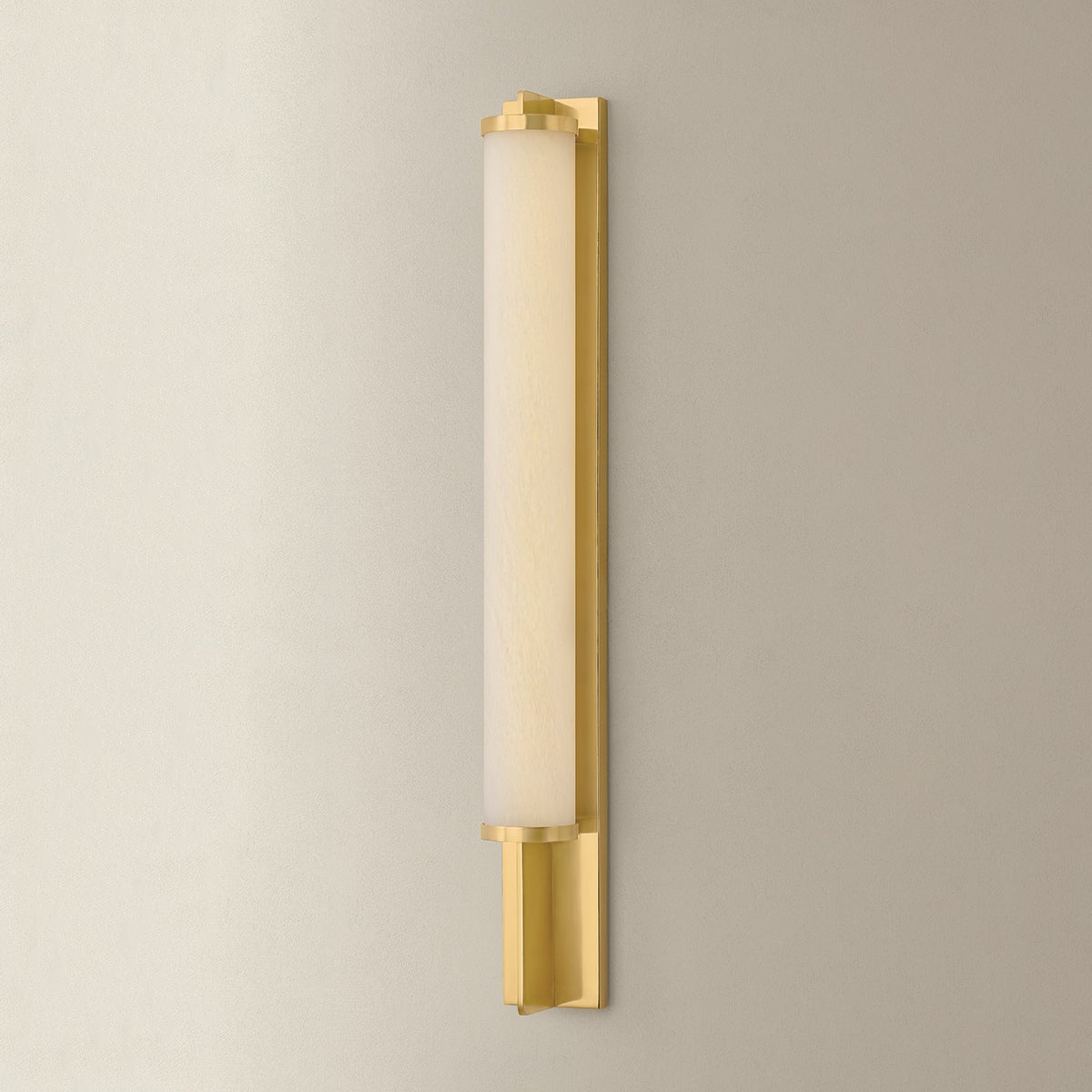 Northfield Wall Sconce 2.75" in aged brass shown from the front to reveal the arm curve and shade silhouette.