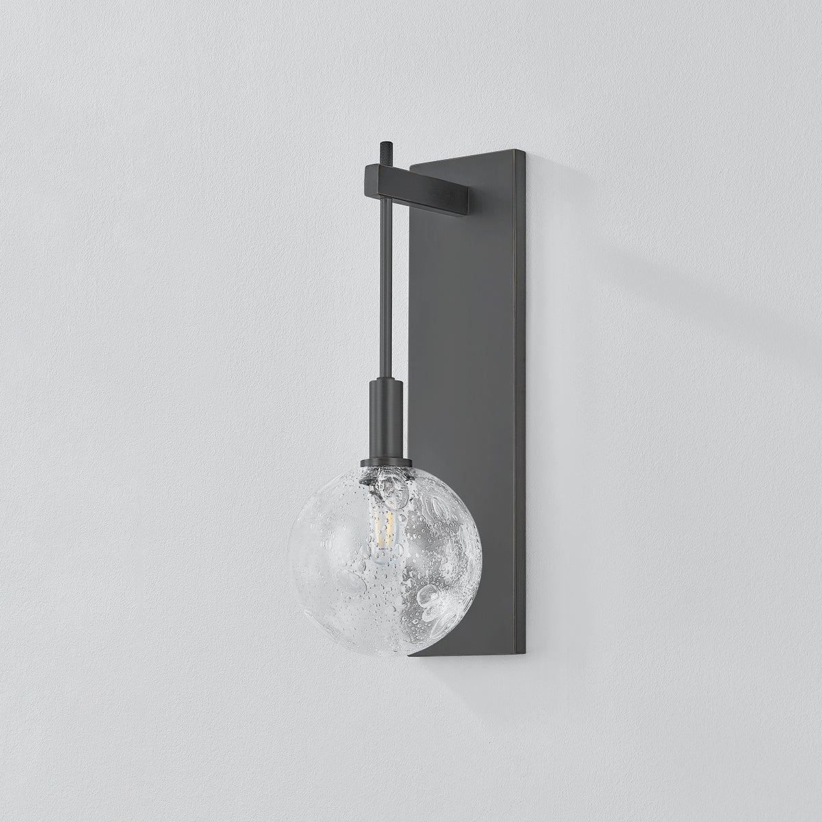 Close-up of the Onteora Wall Sconce in dark bronze showing the arm curve and shade silhouette.