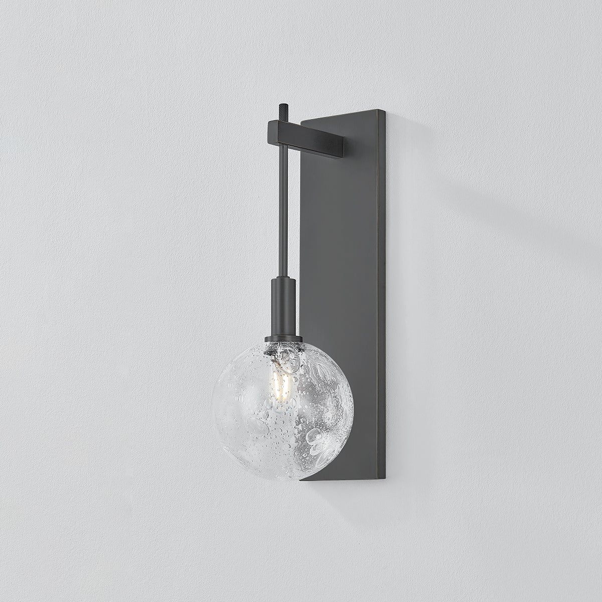 Close-up of the Onteora Wall Sconce in dark bronze showing the arm curve and shade silhouette.