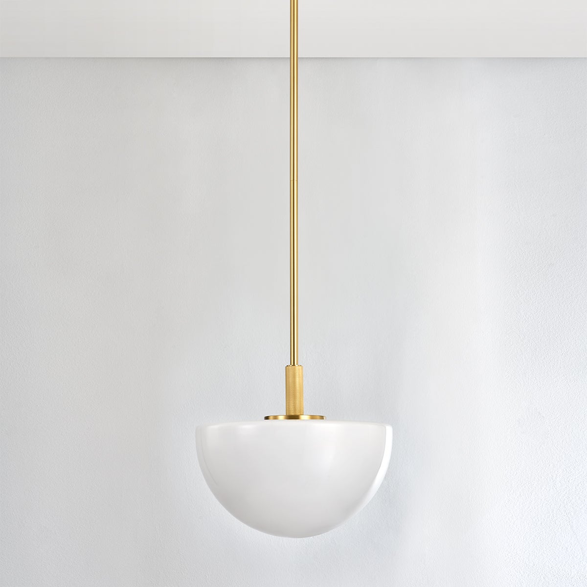 Close-up of the Lethbridge Pendant 15" in aged brass showing the shade shape and metal detail.