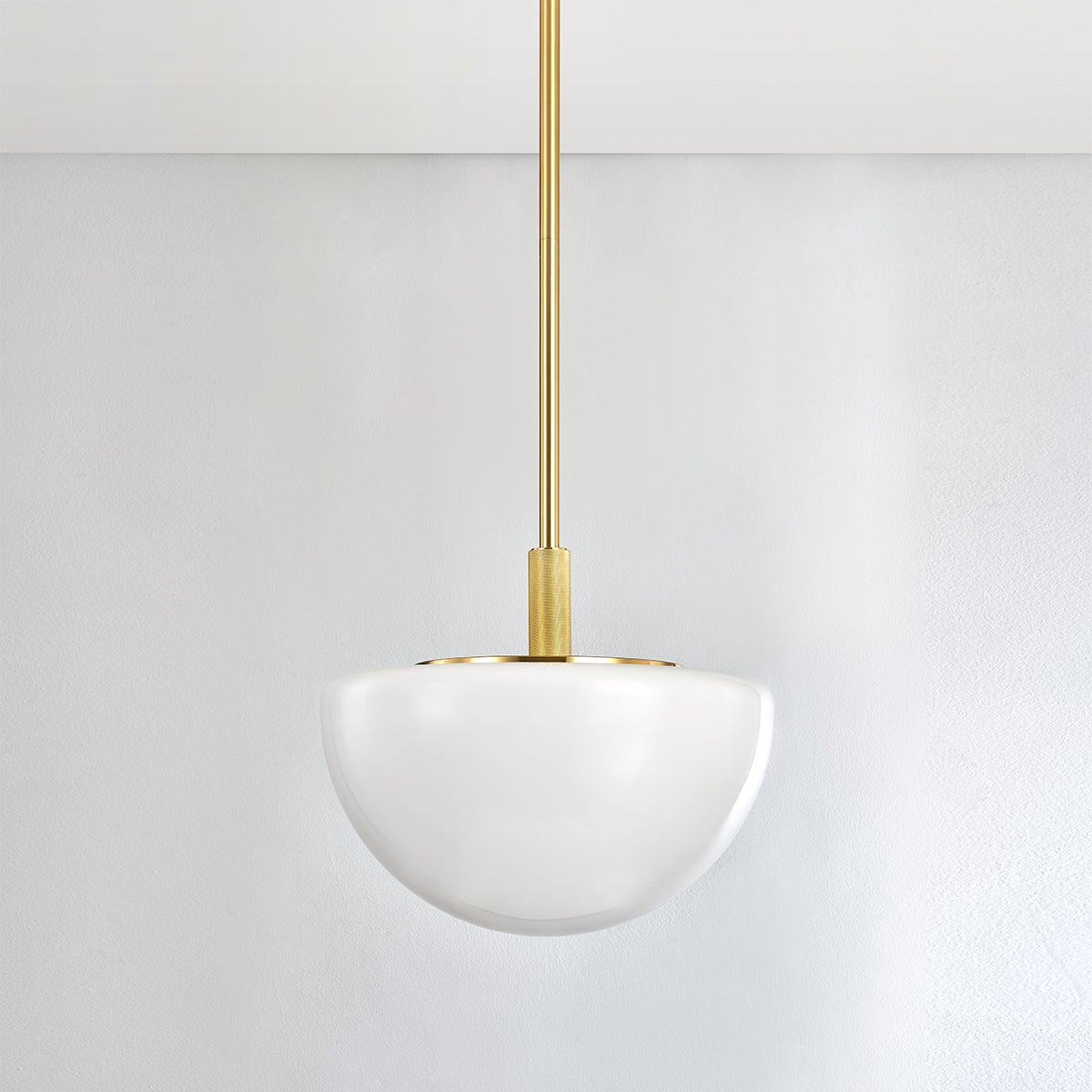 Close-up of the Lethbridge Pendant 19" in aged brass showing the shade shape and metal detail.