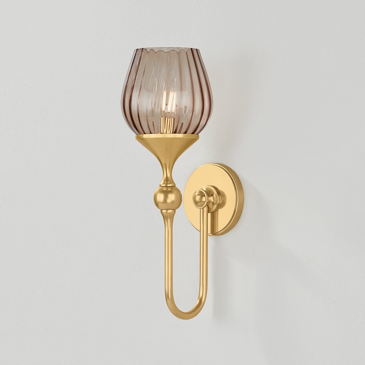 Chatton Wall Sconce in aged brass shown from the front to reveal the arm curve and shade silhouette.