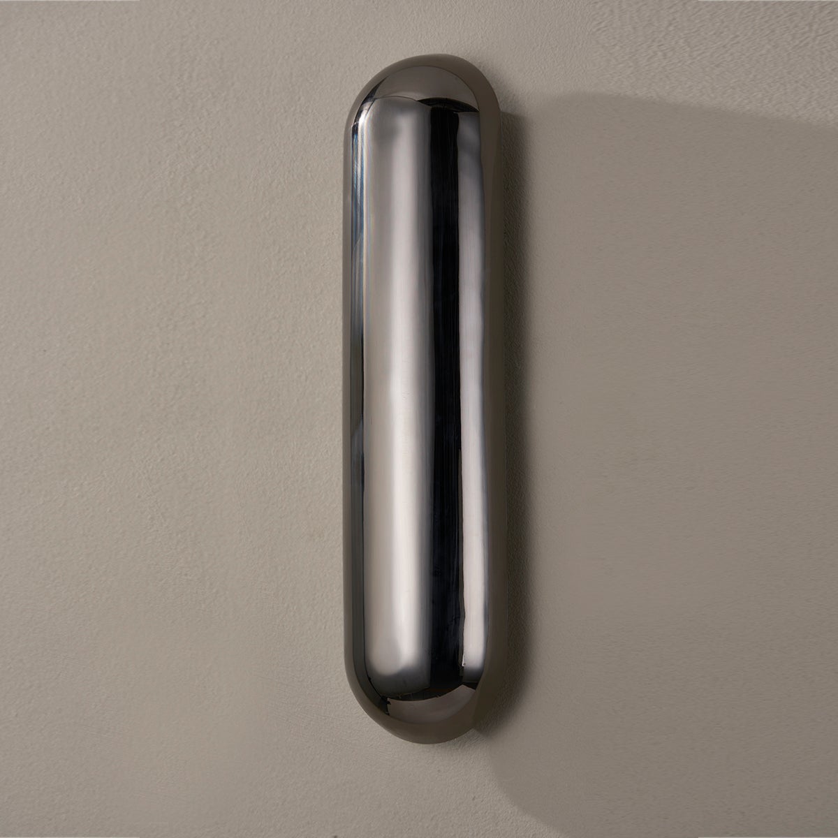 Close-up of the Wheeler Wall Sconce showing the arm curve and shade silhouette.