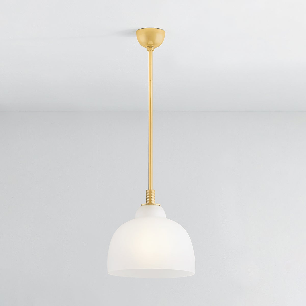 Oberon Pendant 14" in aged brass shown from the front to reveal the shade shape and metal detail.