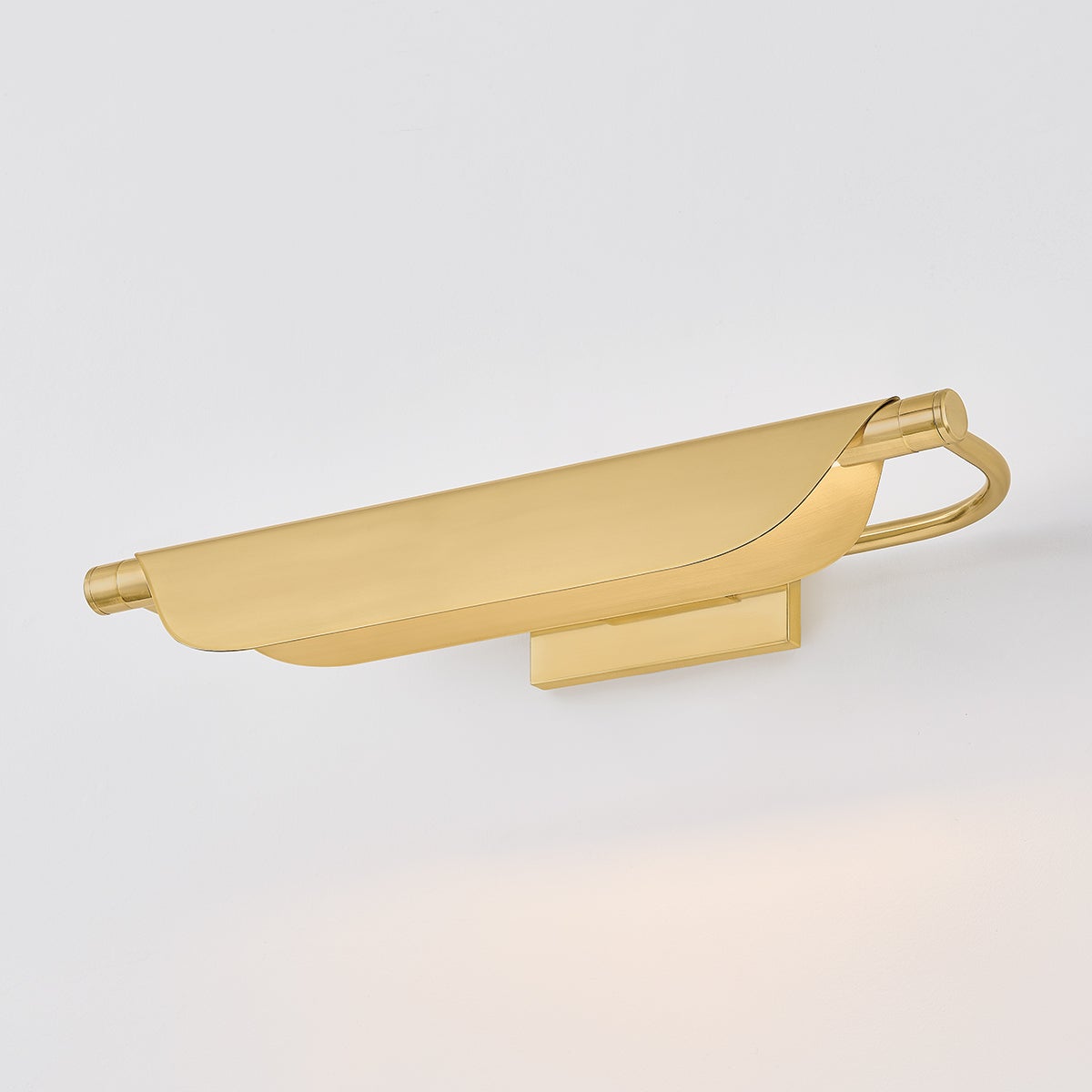 Tinwald Picture Light 19.25" in aged brass shown from the front to reveal the arm curve and shade proportion.