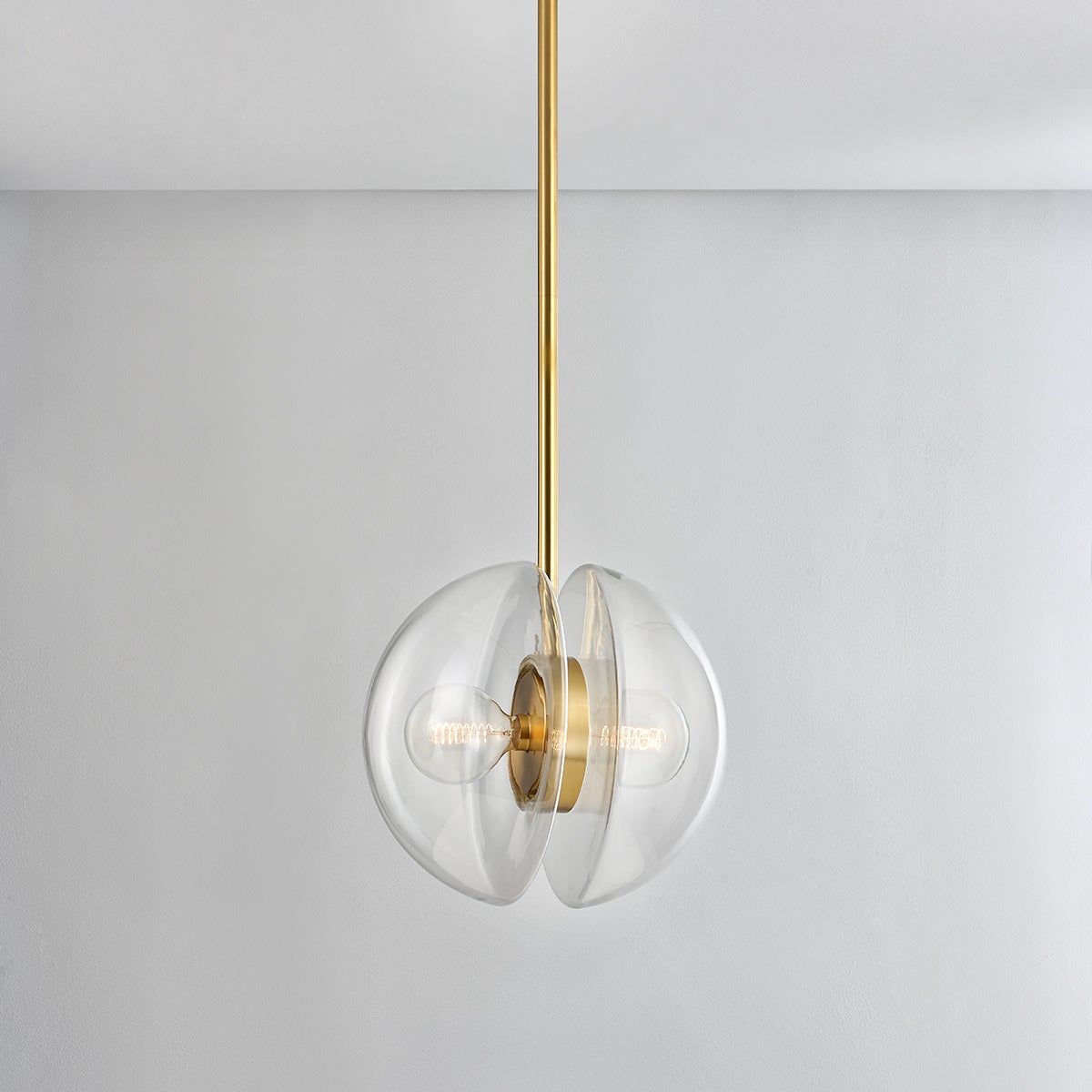 Close-up of the Kert Pendant 17" in aged brass showing the shade shape and metal detail.