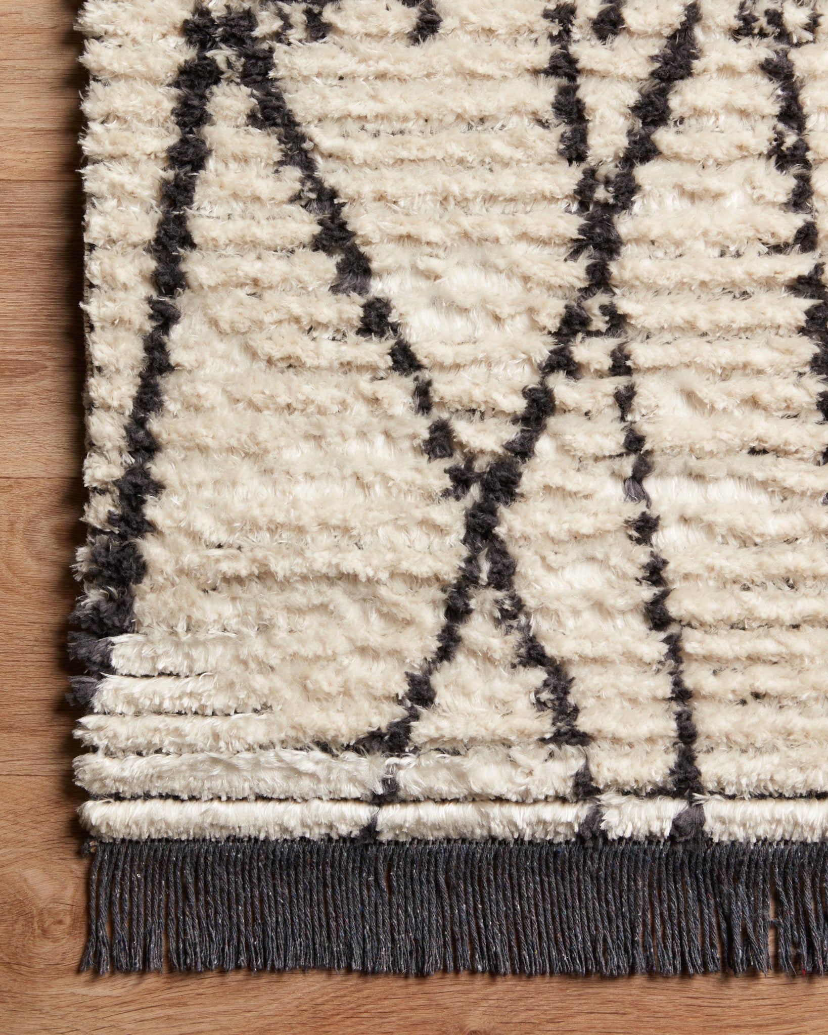Alice Cream / Charcoal by Chris Loves Julia x Loloi (Pattern 1) shown in a curated living room setting at Laurie Yapp Home.