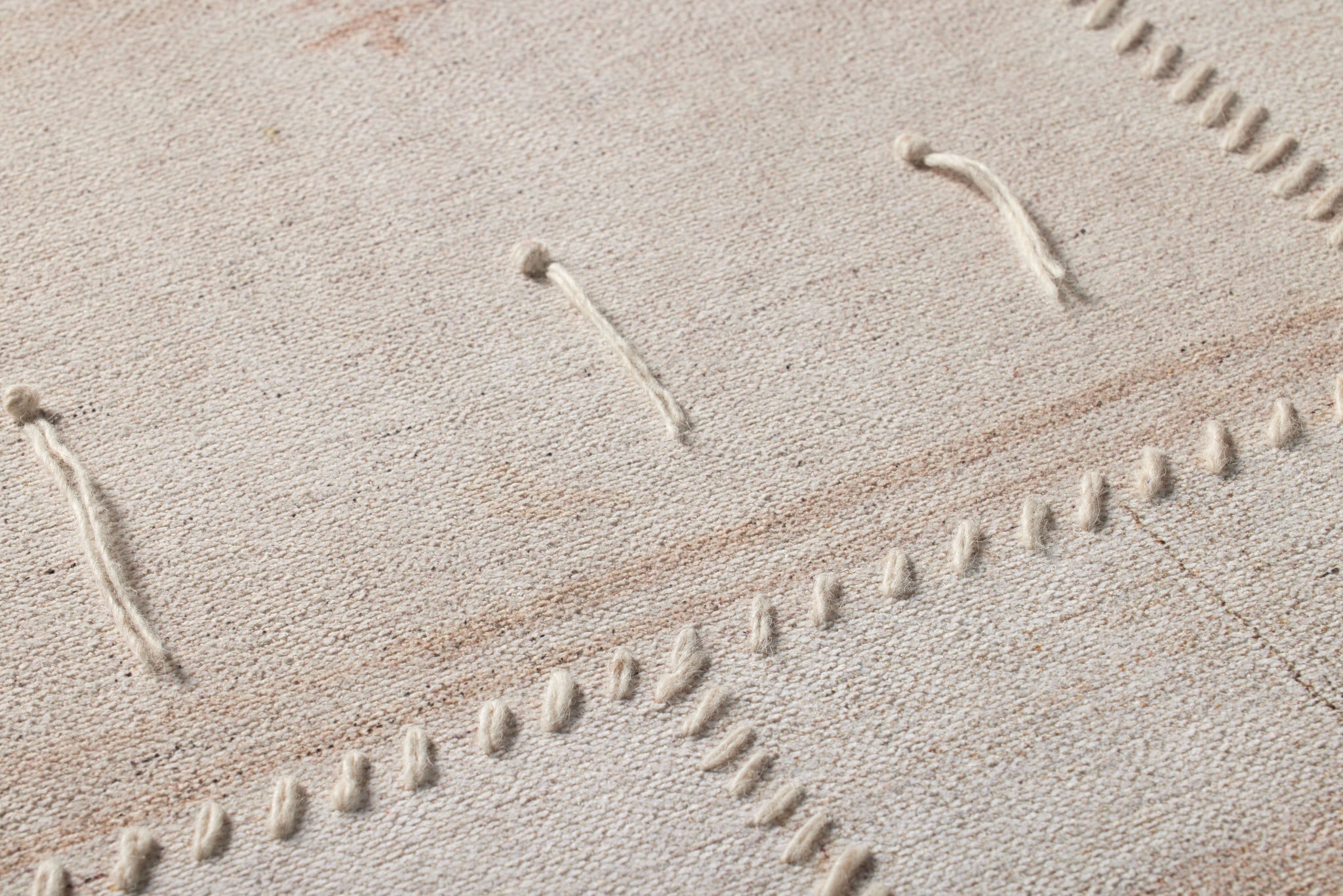 Revived Beige / Ivory Rug Art shown from a different angle to reveal its pattern.