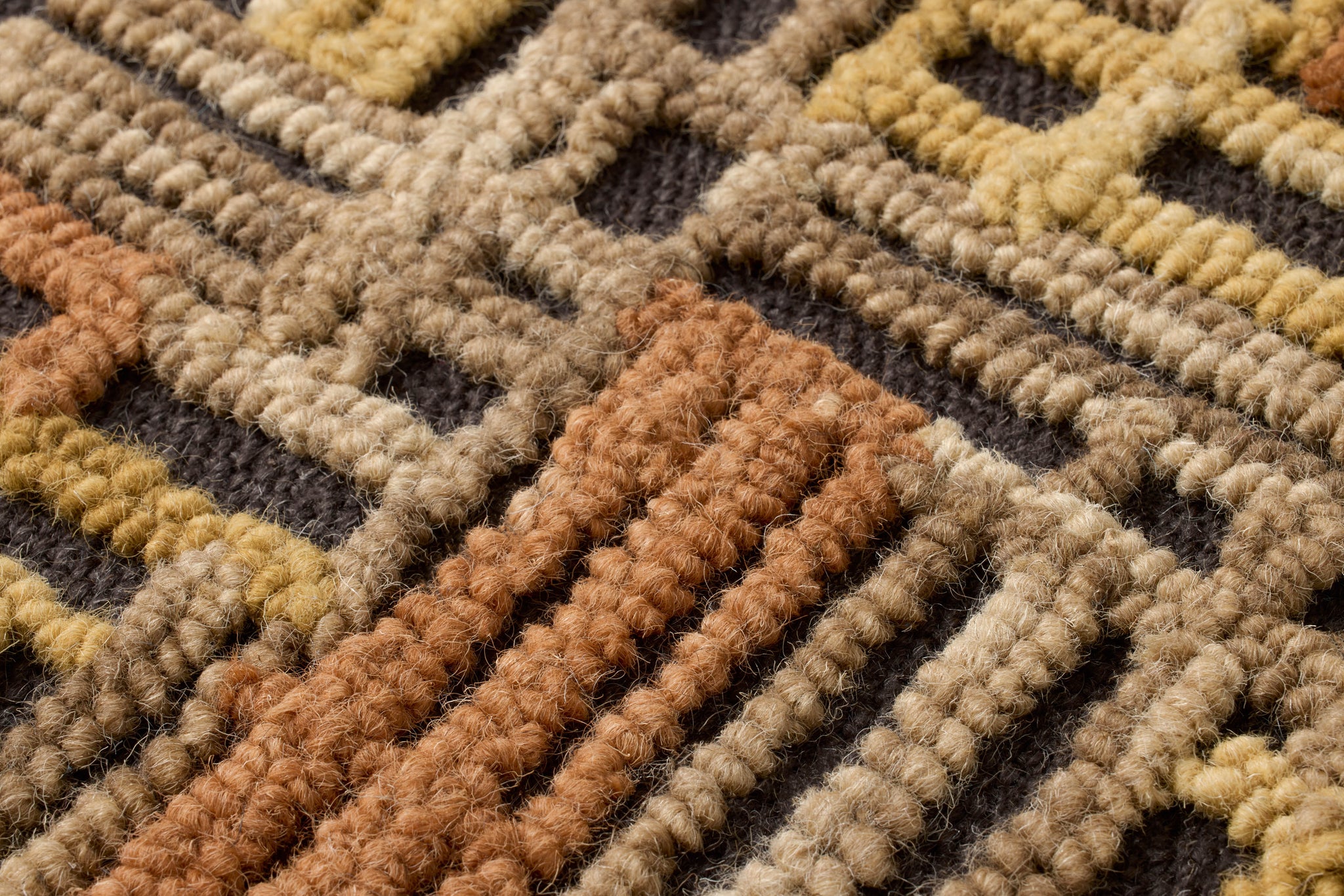 Perpindicular Gold / Orange Rug Art shown from a different angle to reveal its pattern.