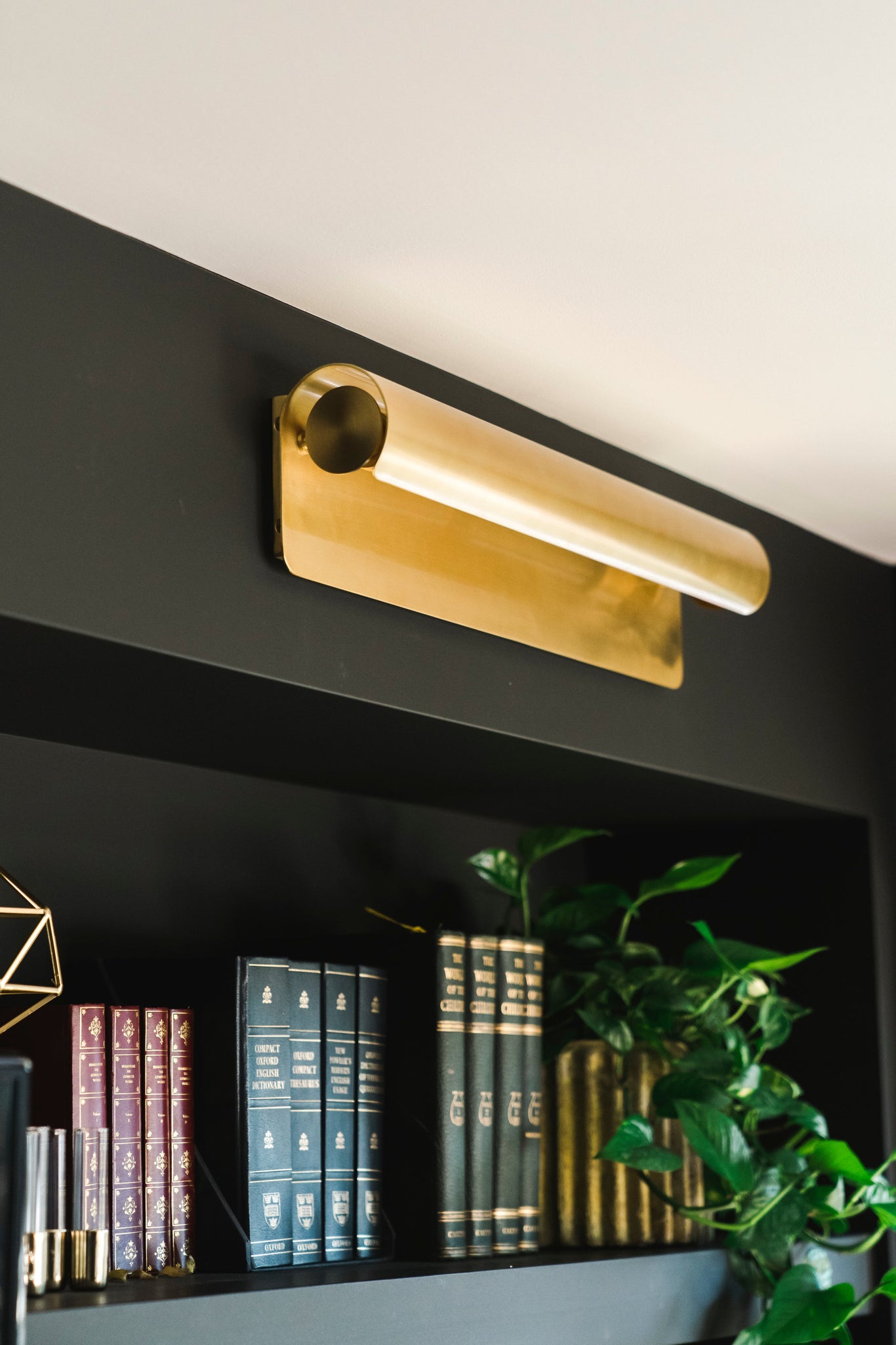 Close-up of the Accord Wall Sconce 5.5" x 25" in aged brass showing the arm curve and shade silhouette.