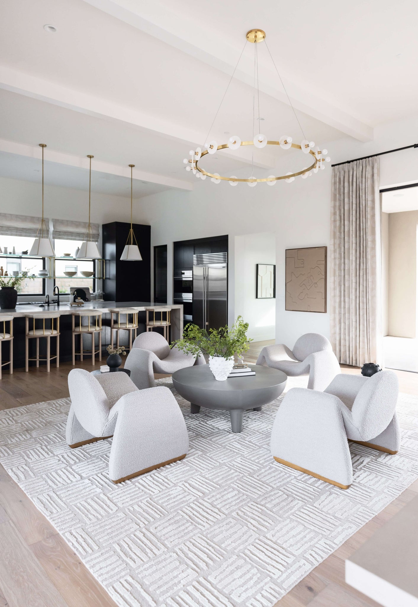 Austen Chandelier 58" x 4.75" in aged brass styled in a two-story entry for warm, layered light at Laurie Yapp Home.