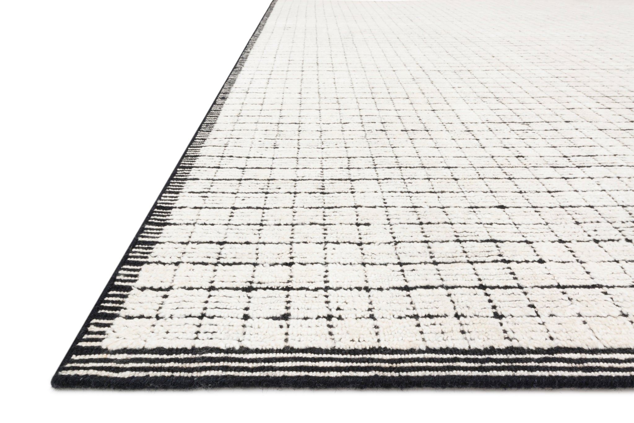 Side view of the Beverly Ivory / Black rug.