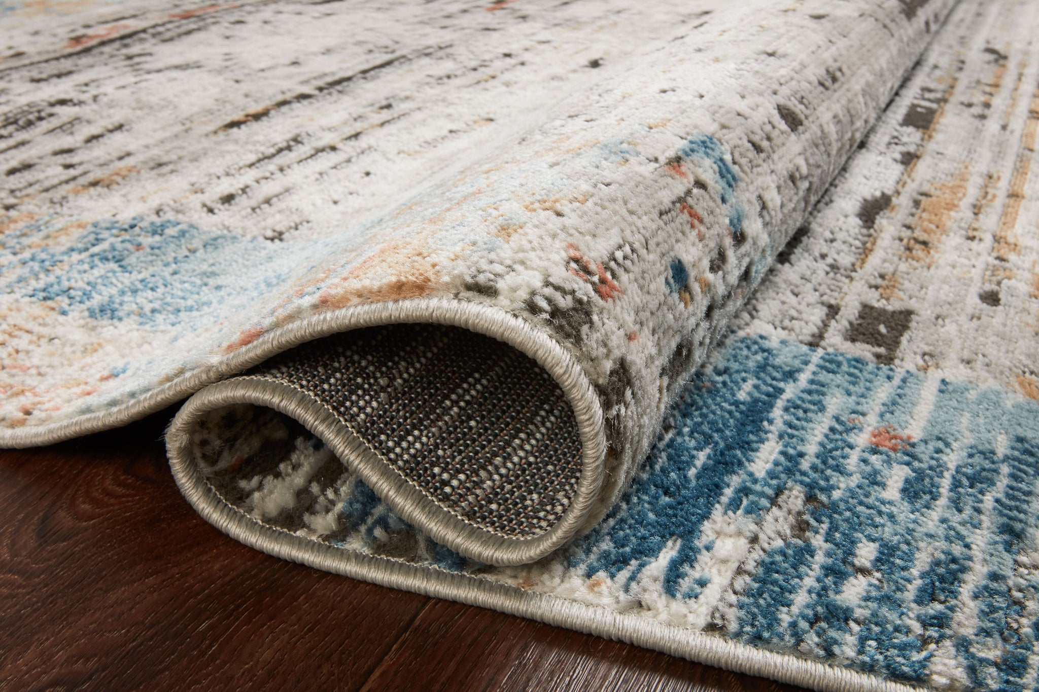 Side view of the Bianca Ash / Multi rug.