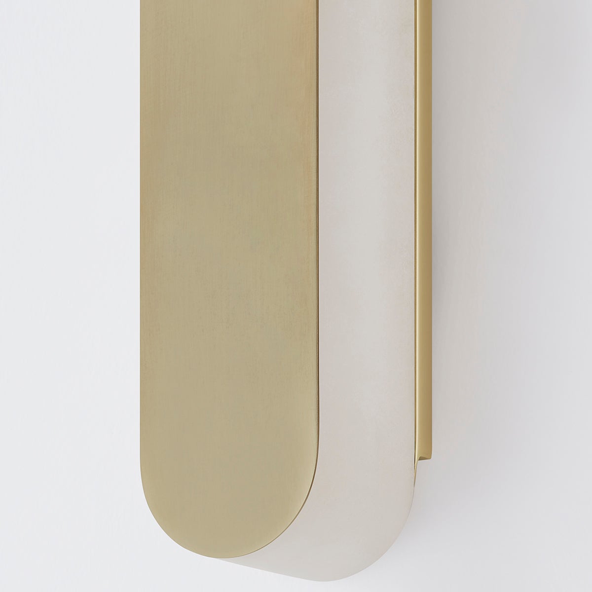 Close-up of the Briarwood Wall Sconce 3.75" in aged brass showing the arm curve and shade silhouette.