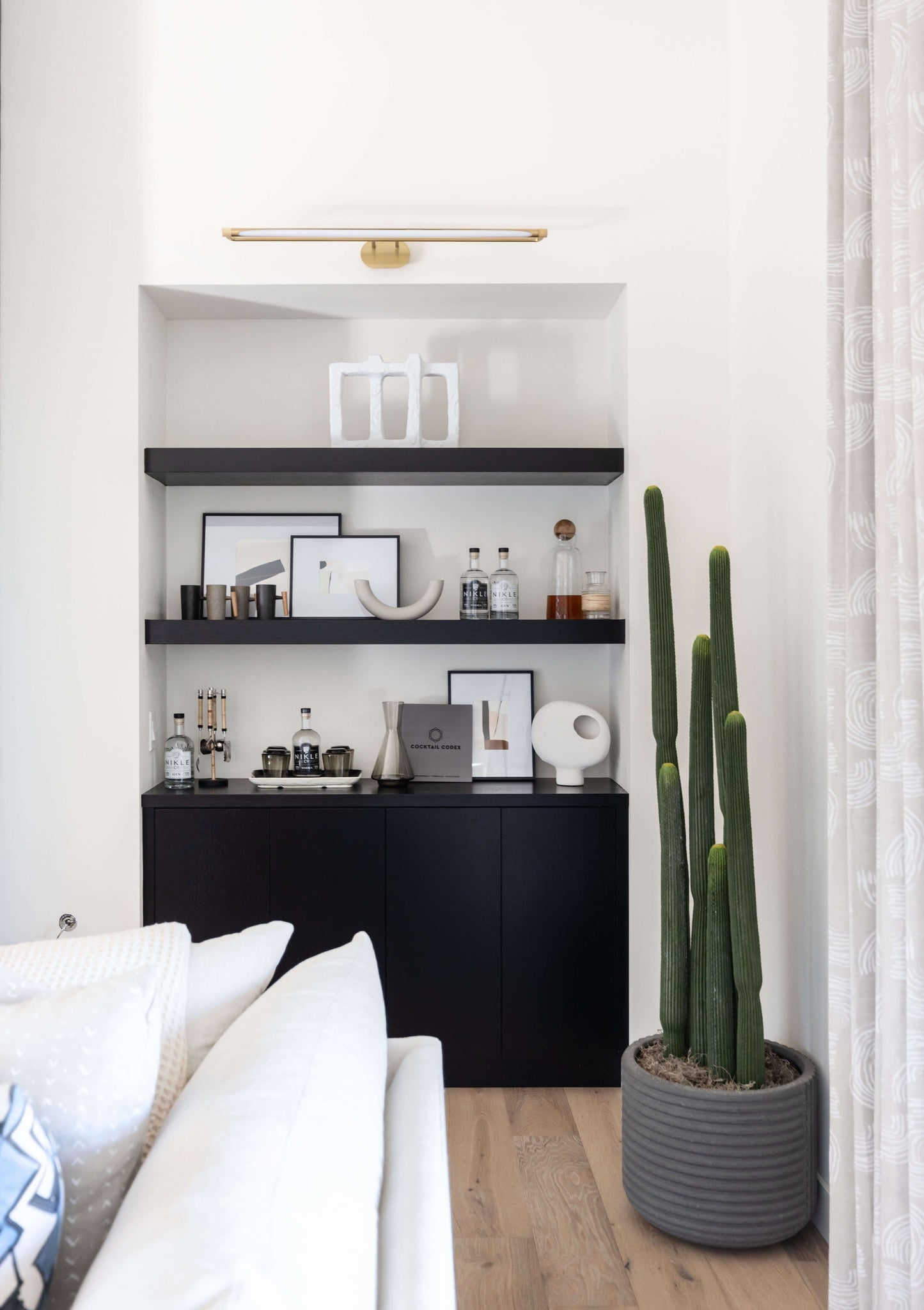 Berkshire Picture Light 37" in aged brass styled in a gallery wall for warm, layered light at Laurie Yapp Home.
