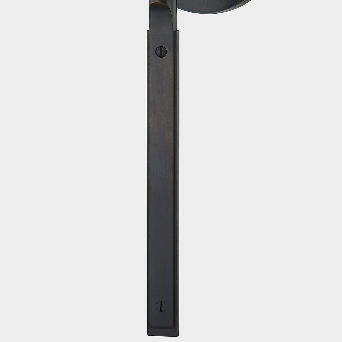 Close-up of the Brewster Wall Sconce in bronze showing the arm curve and shade silhouette.