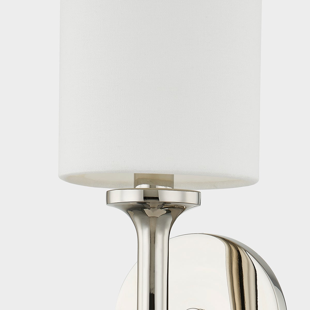 Close-up of the Brewster Wall Sconce in polished nickel showing the arm curve and shade silhouette.
