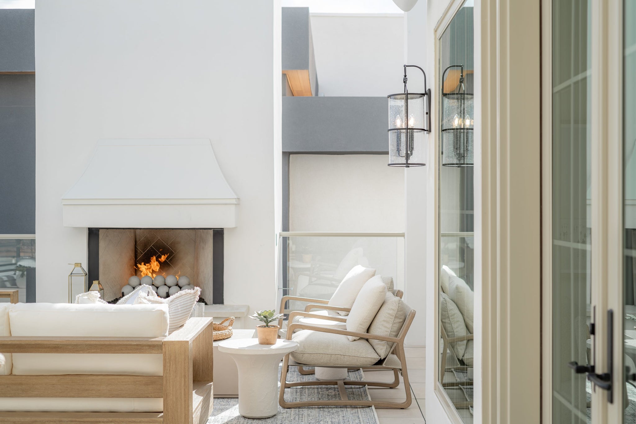 Burbank Exterior Wall Sconce 10" styled in a curated living room for warm, layered light at Laurie Yapp Home.