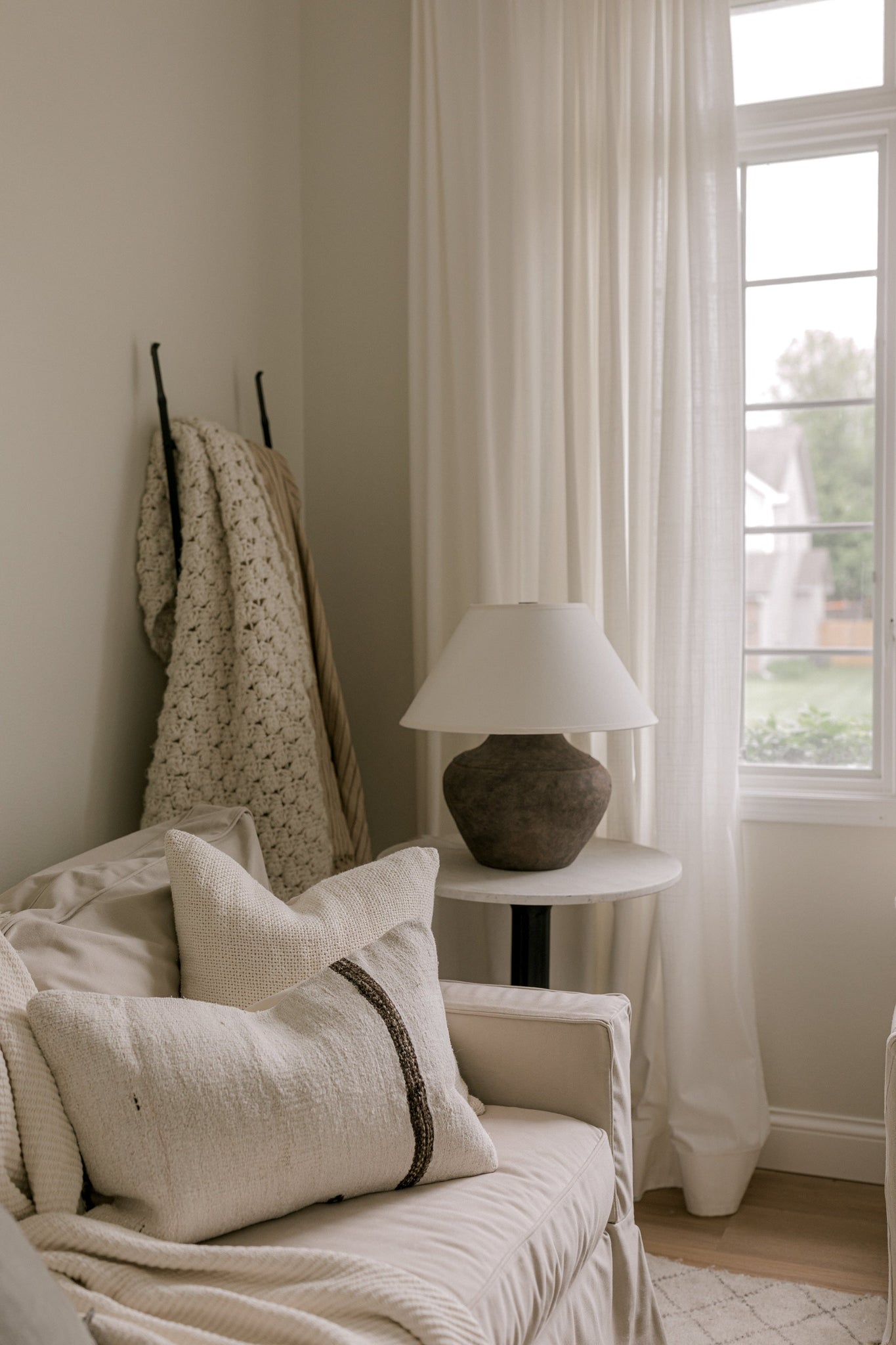 Calabria Table Lamp 20" styled in a living room side table for warm, layered light at Laurie Yapp Home.