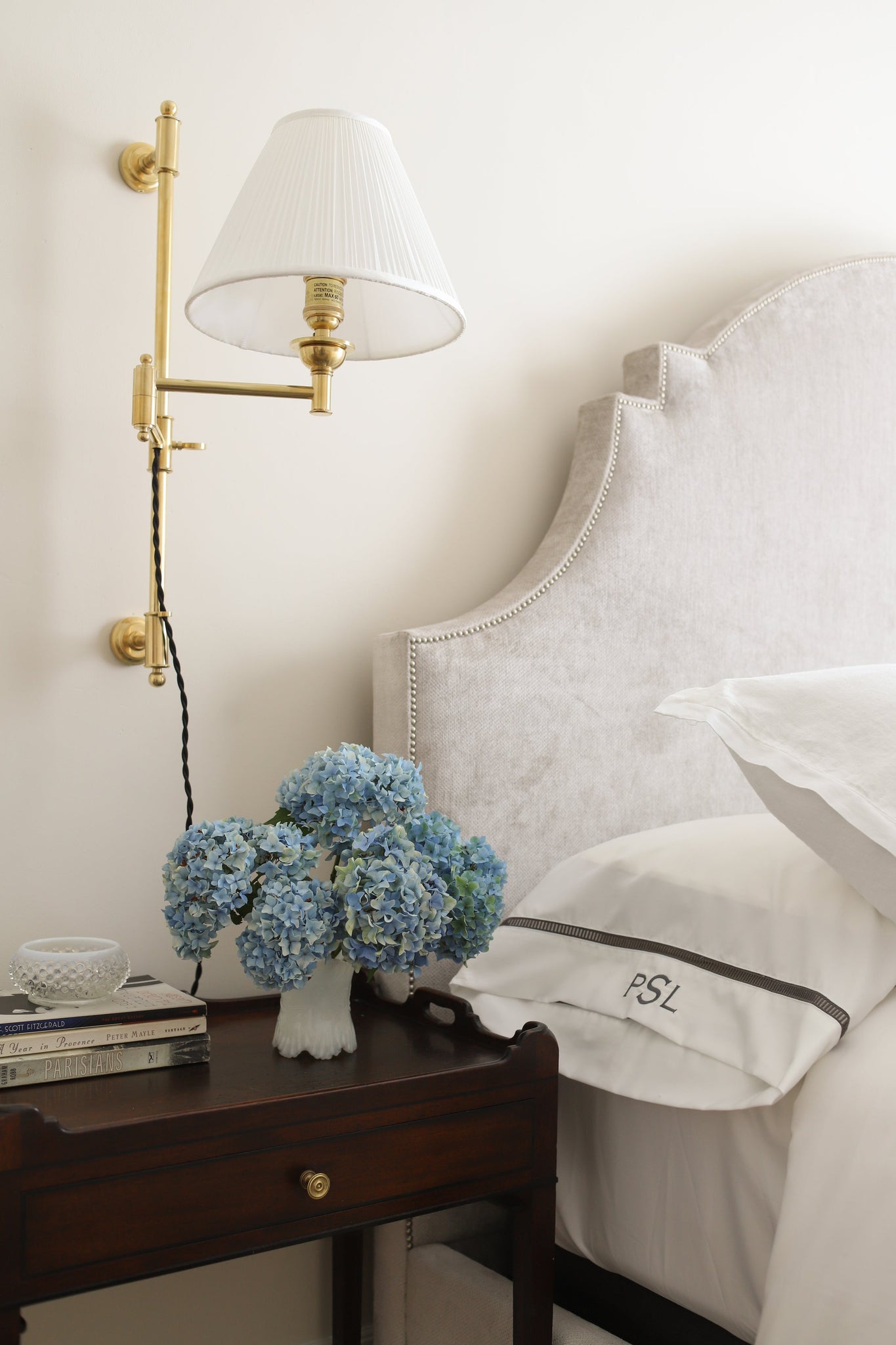 Classic No.1 Plug-In Sconce in aged brass styled in a reading nook for warm, layered light at Laurie Yapp Home.