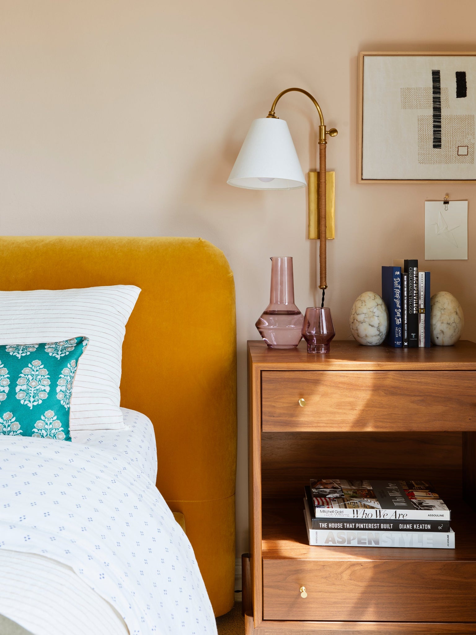 Curves No.1 Plug-In Sconce in aged brass styled in a bedroom for warm, layered light at Laurie Yapp Home.
