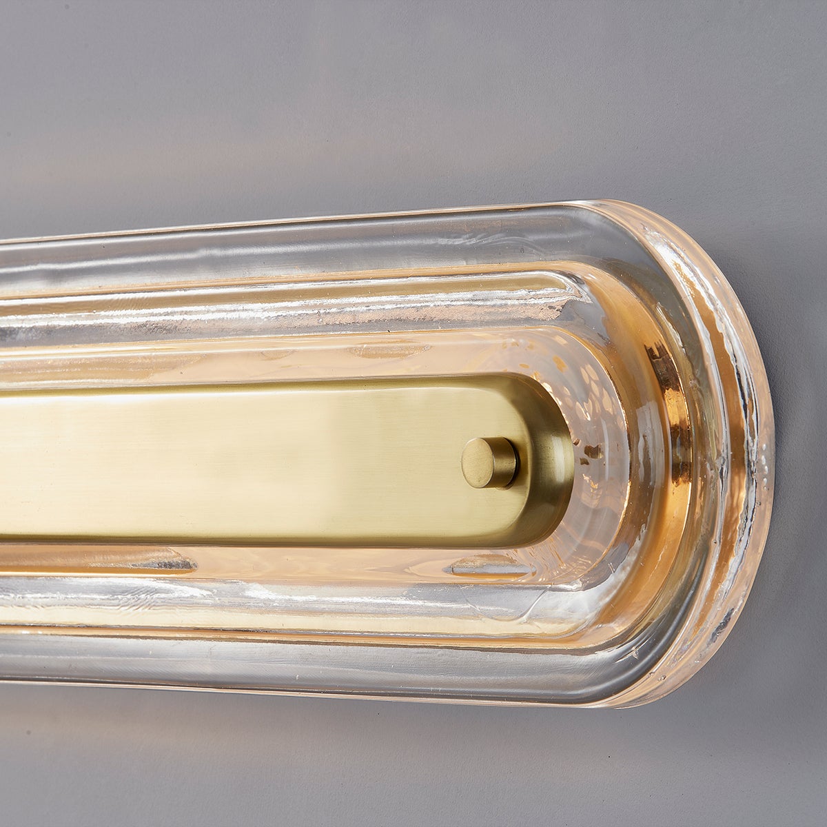 Litton Wall Sconce 5.75" x 21.25" in aged brass shown from the front to reveal the arm curve and shade silhouette.