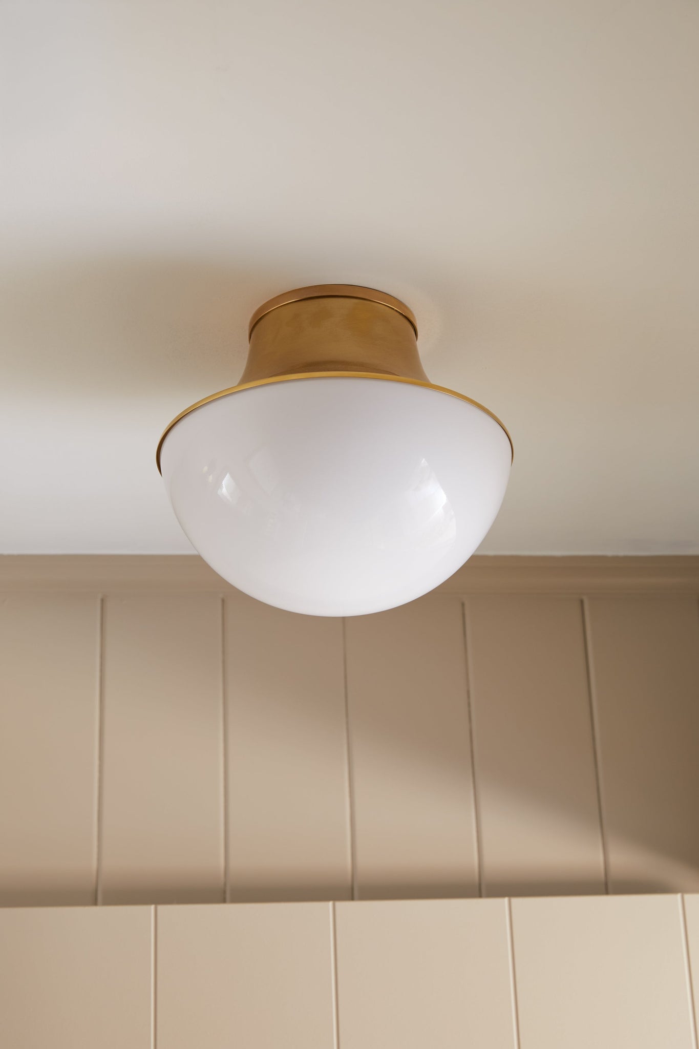 Lettie Flush Mount 14.75" in aged brass styled in a hallway for warm, layered light at Laurie Yapp Home.