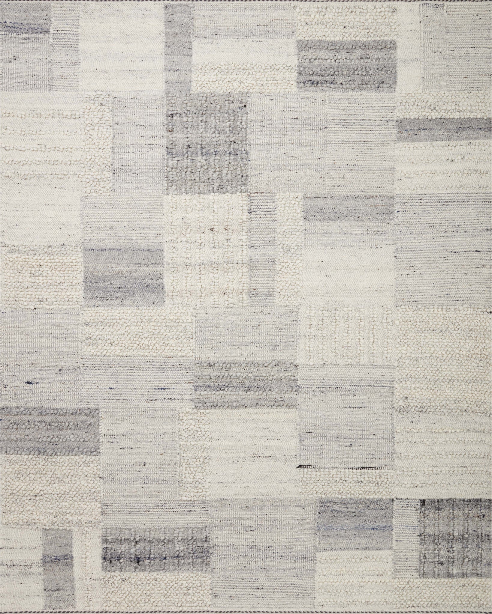 Side view of the Manfred Slate / Mist rug.