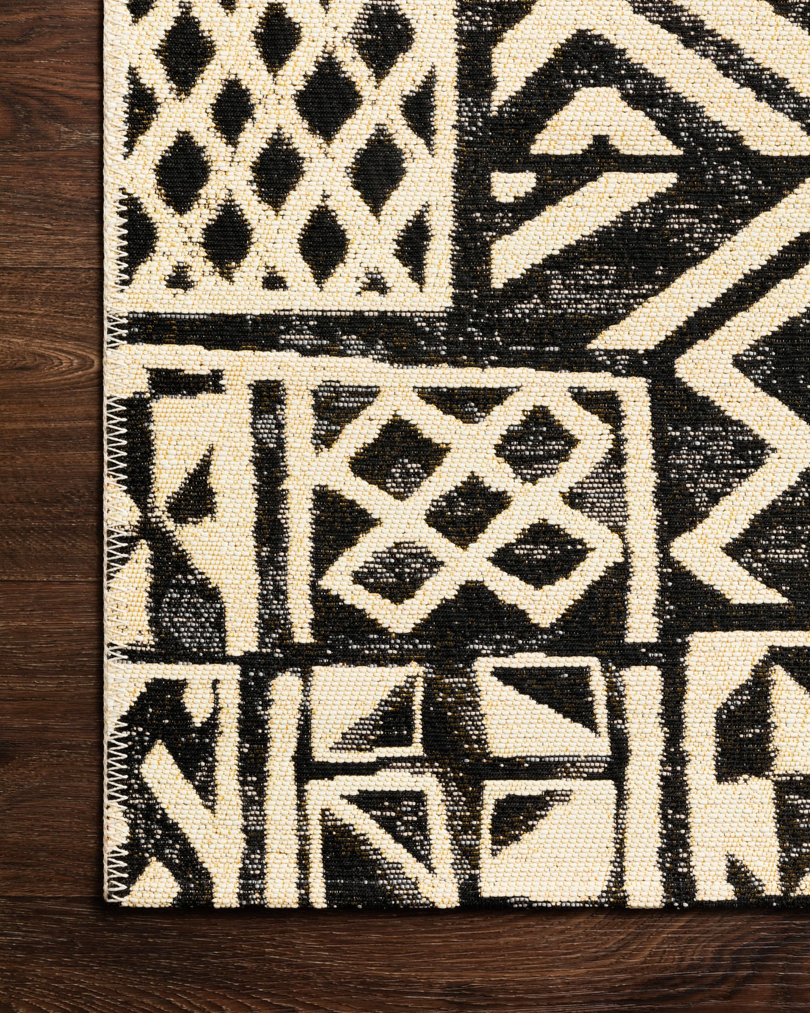 Close-up detail of the Mika Ivory / Black showing its pile and weave.