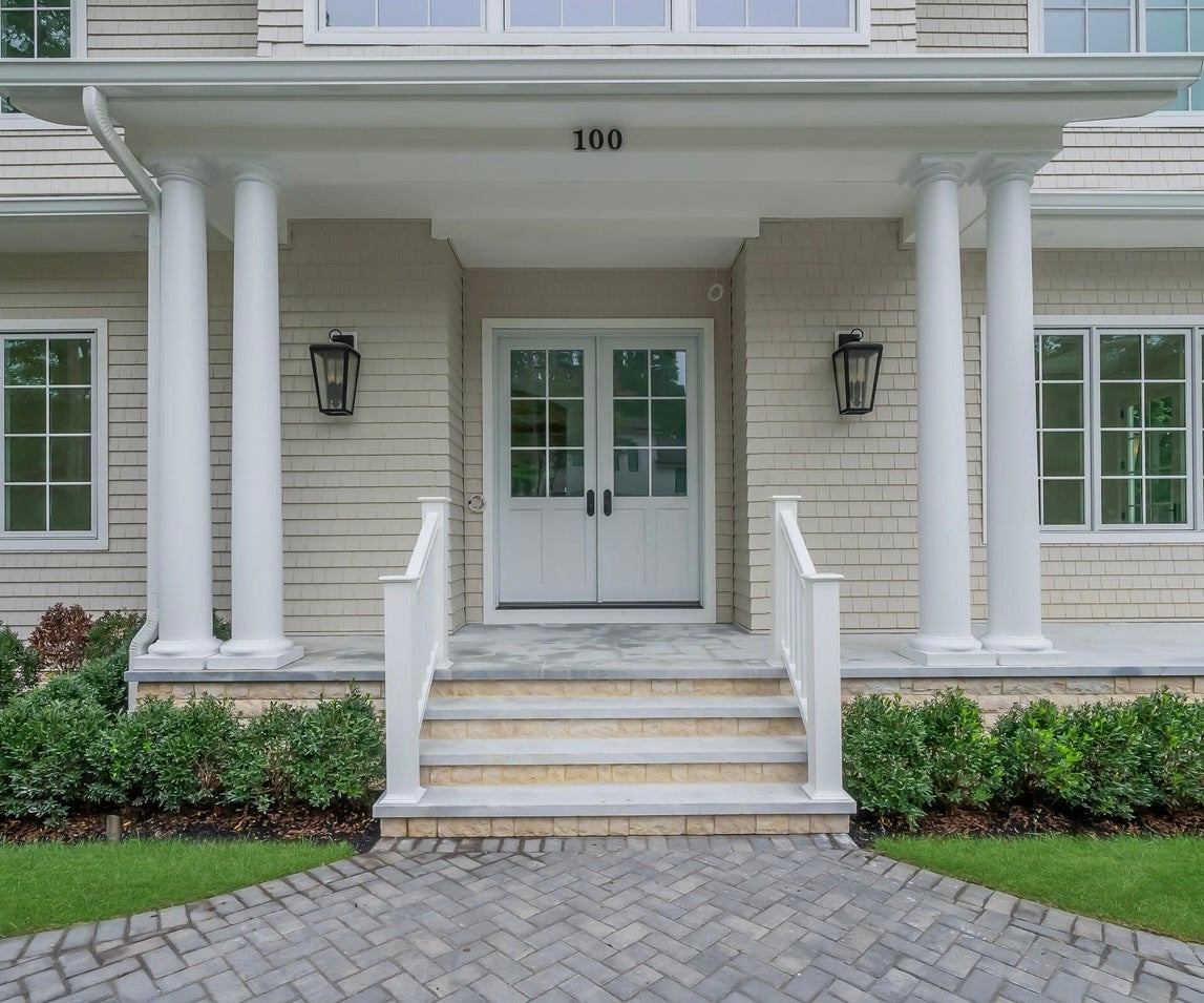 Mariden Exterior Wall Sconce 11.5" styled in a warmly lit hallway for warm, layered light at Laurie Yapp Home.